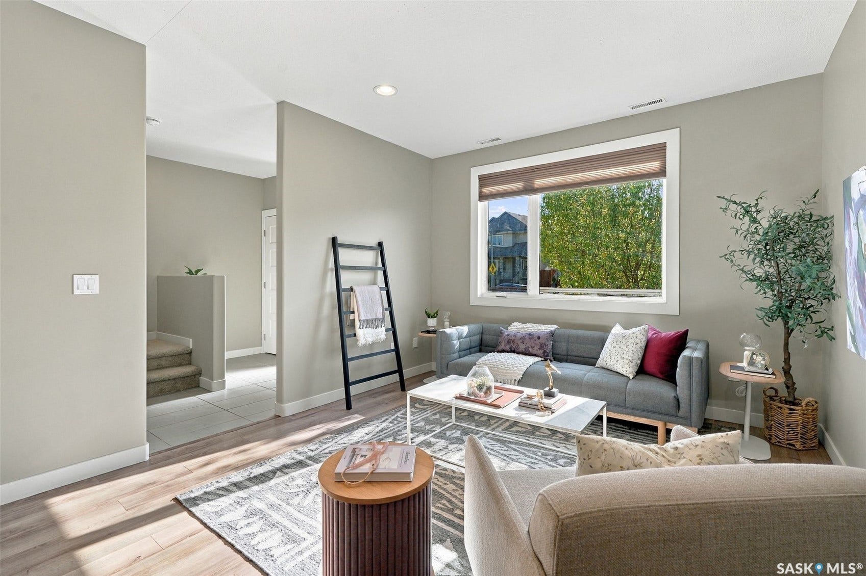 Recessed lighting, wood-finish flooring, and light-toned walls