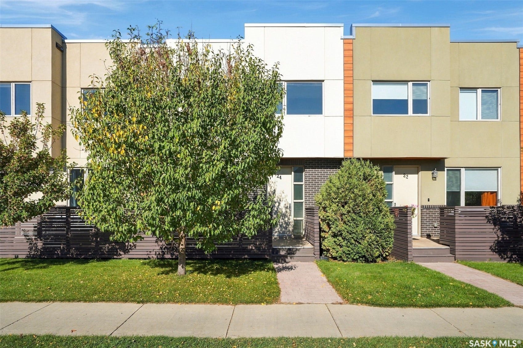 Contemporary townhouse exteriors featuring a combination of smooth panels and brick accents