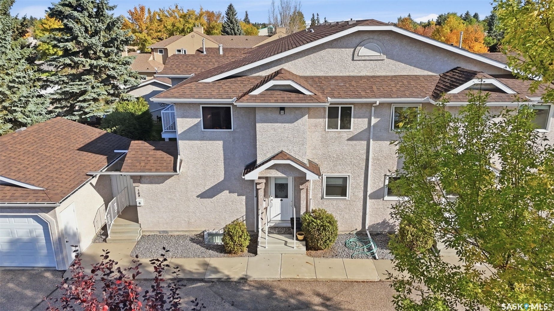 Stucco exterior with multiple gables and a covered entry