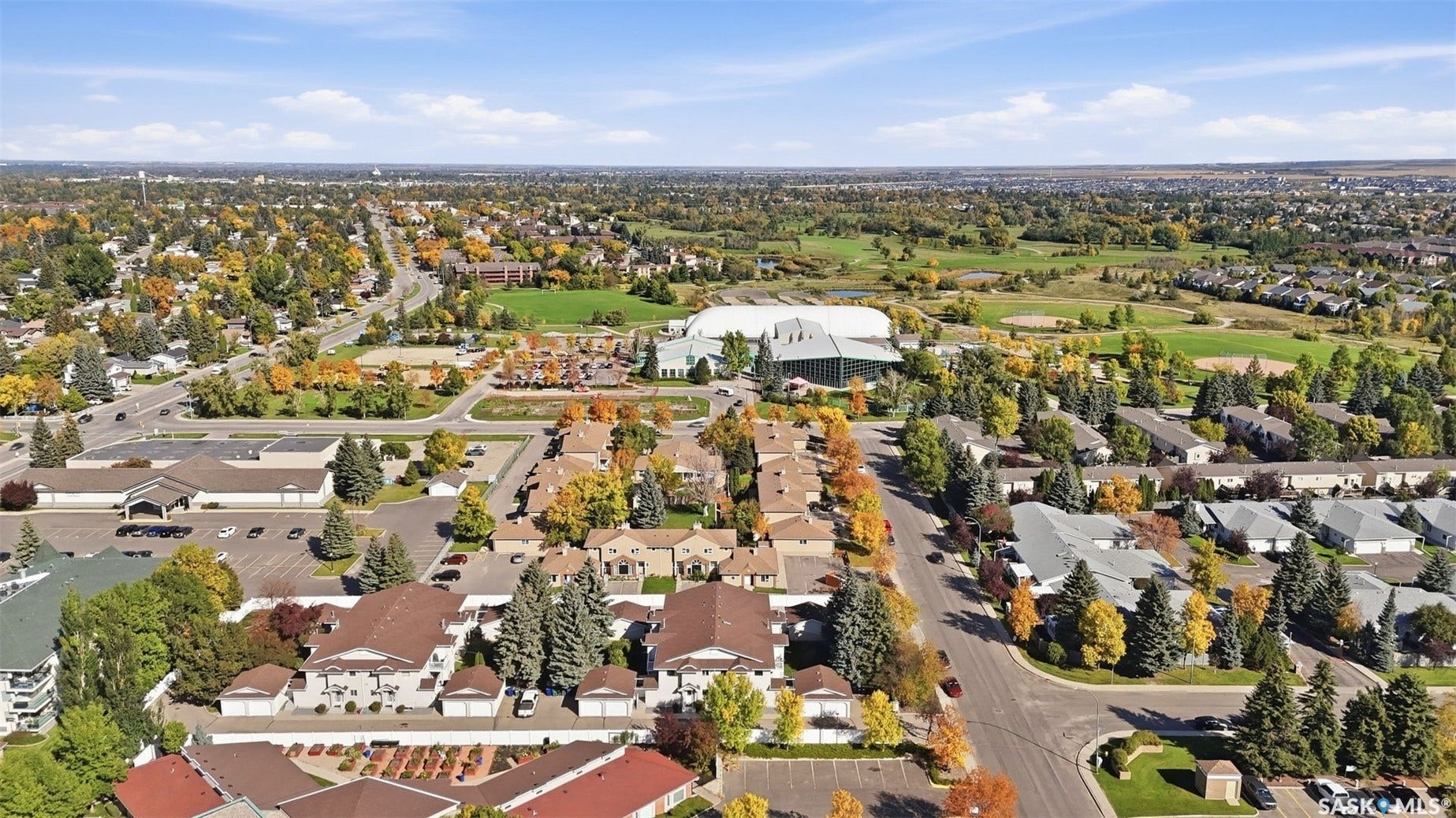 Residential area with varied architectural styles, mature trees, and paved roads