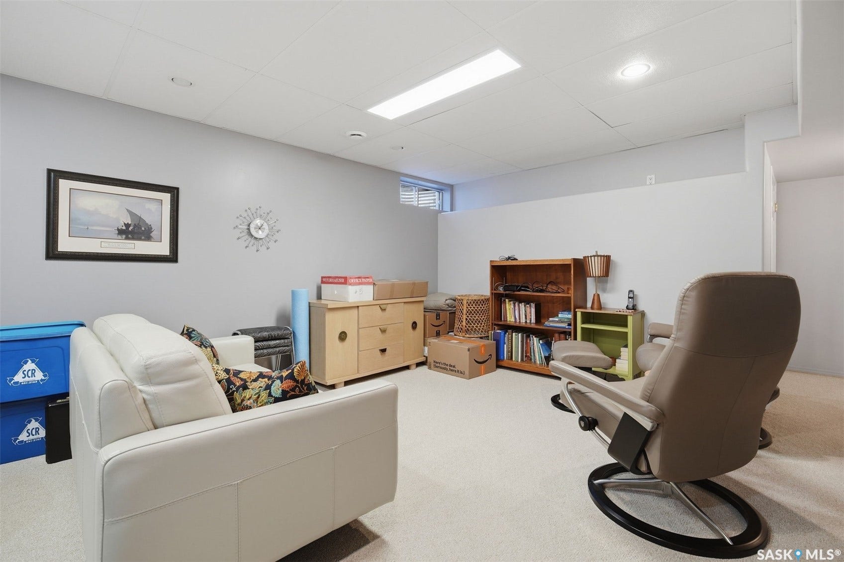 Recessed ceiling lighting, dropped ceiling panels, and light gray wall paint