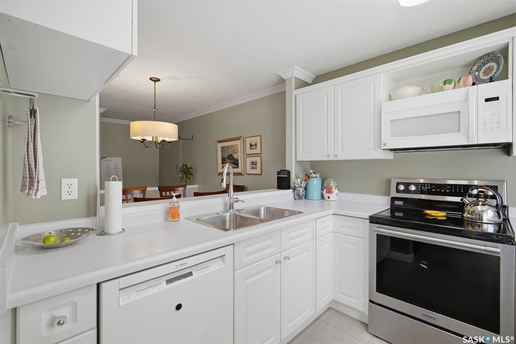 Kitchen featuring white cabinetry, white countertops, a stainless steel double basin sink, and a stainless steel electric range