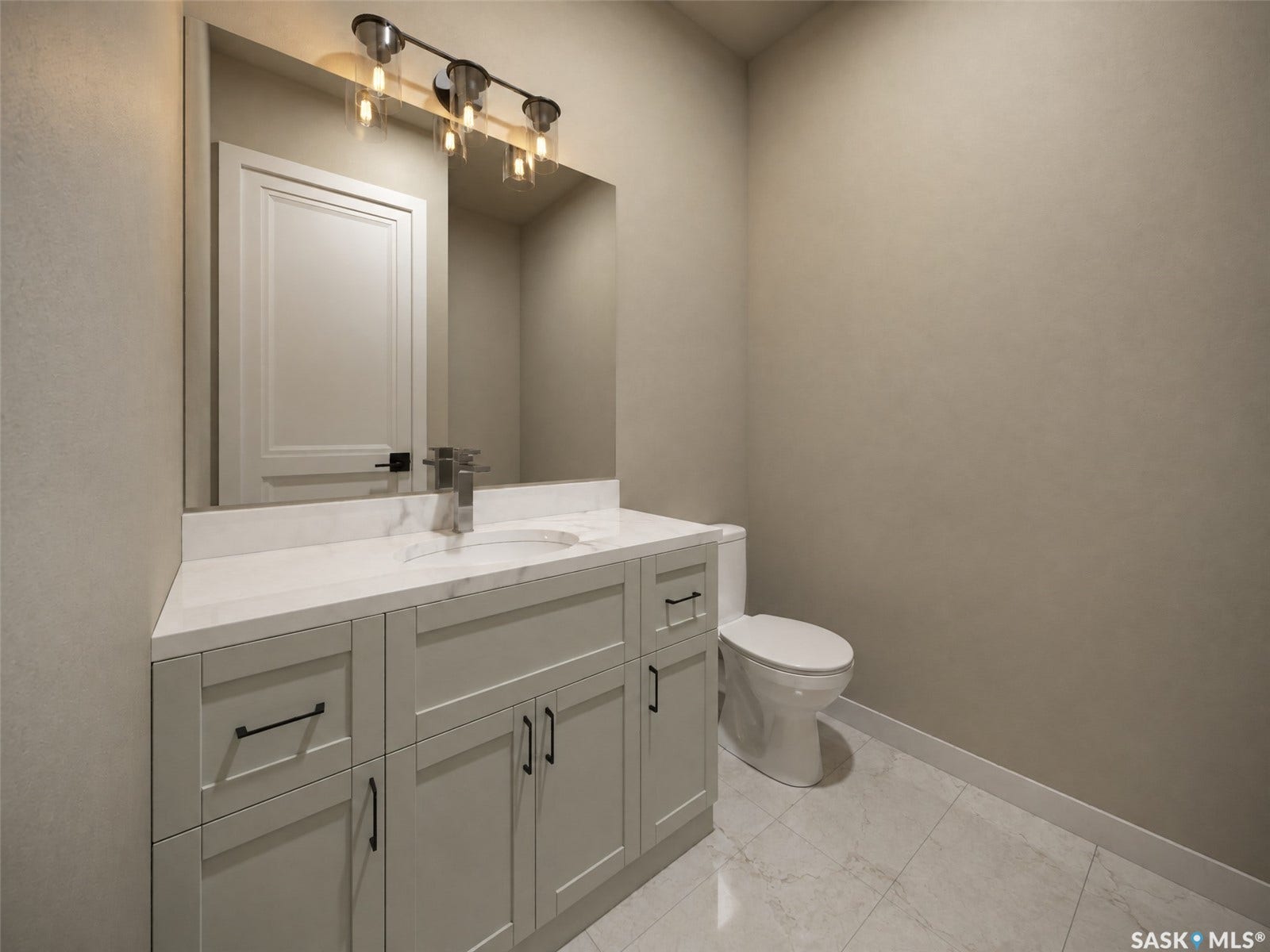 Light-toned vanity with cabinet storage, a white countertop, an undermount sink, and a framed mirror