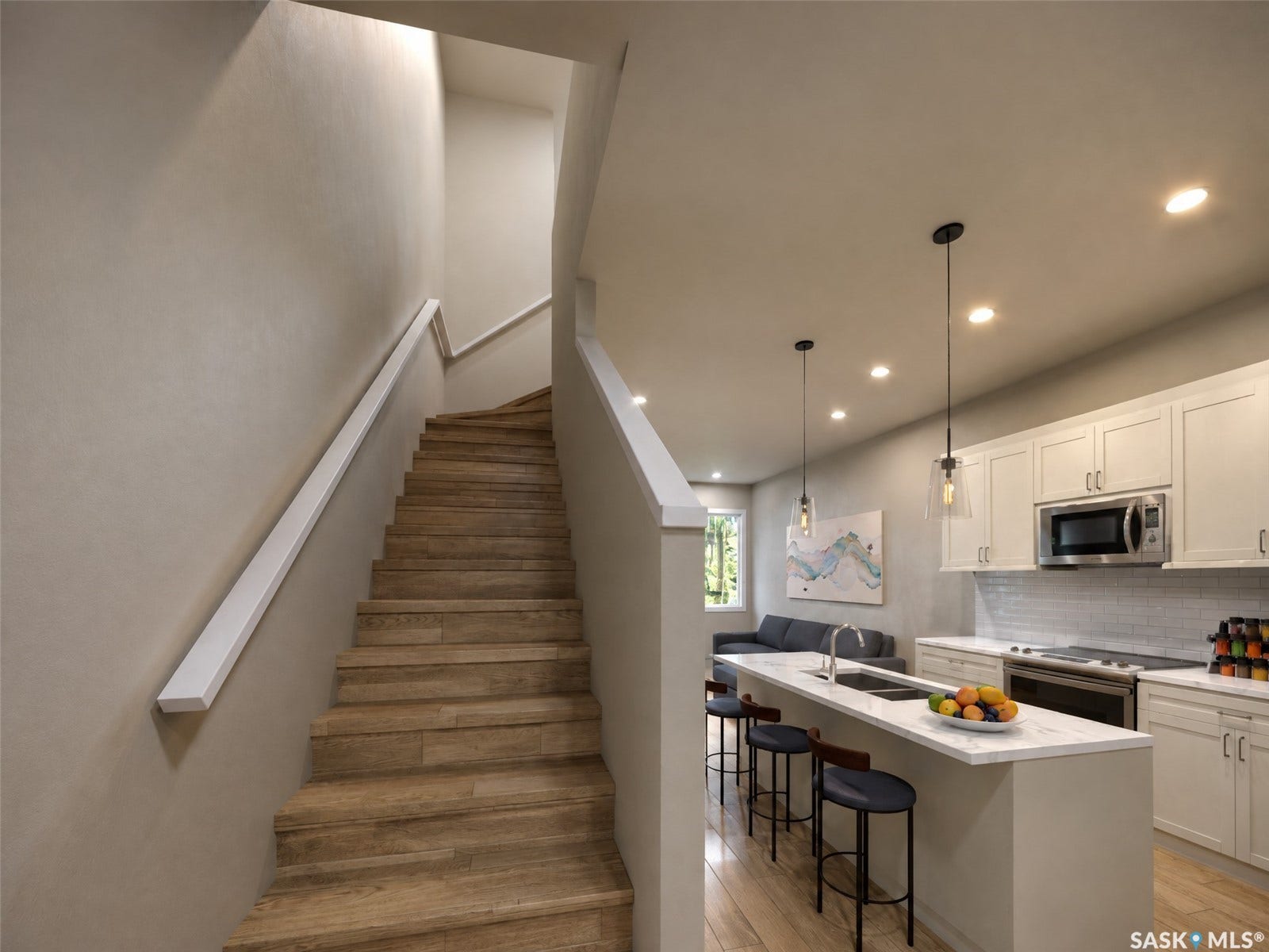 Open-concept kitchen with white shaker cabinetry, stainless steel appliances, and a central island with a sink and pendant lighting