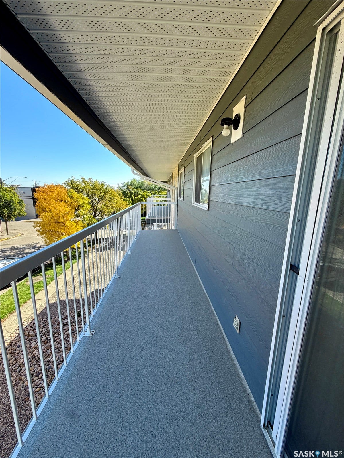 305 1st Street W, #301, Rosetown SK S0L 2V0 Outdoor balcony with a textured gray floor, white metal railing, and dark gray siding