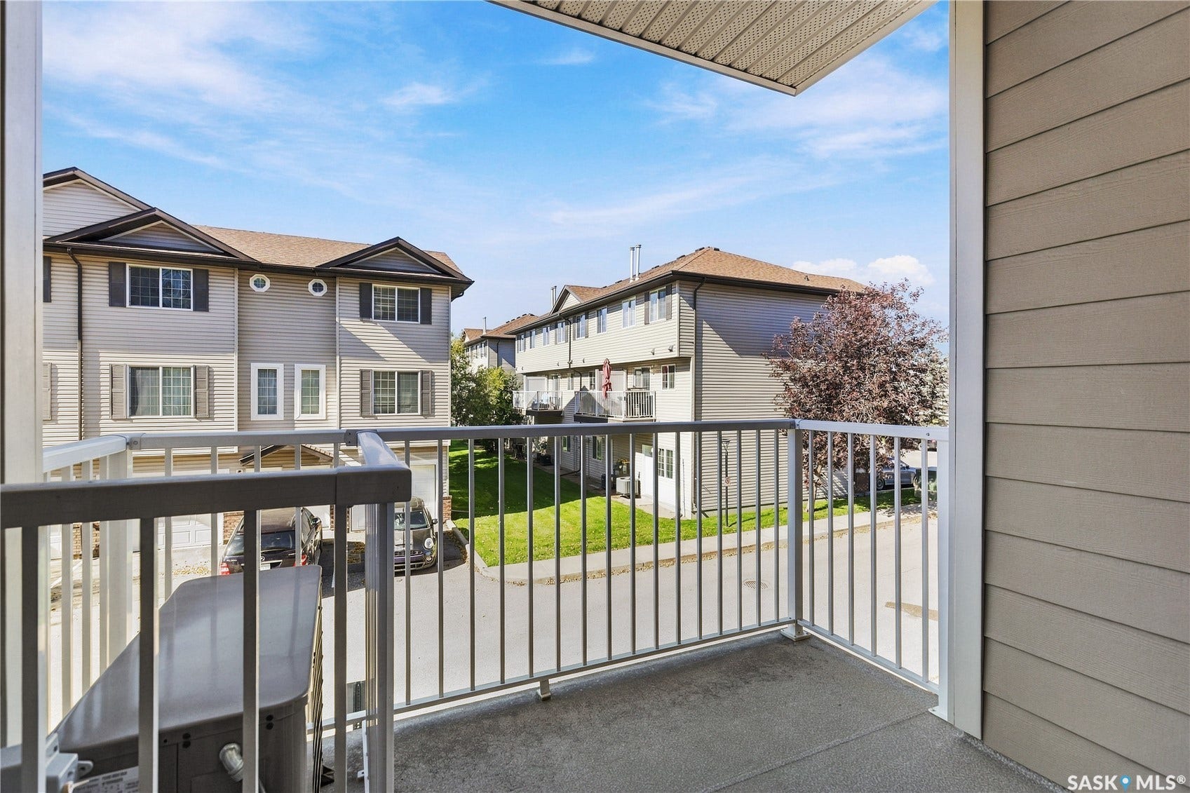 Private balcony with metal railing, concrete flooring, and horizontal siding