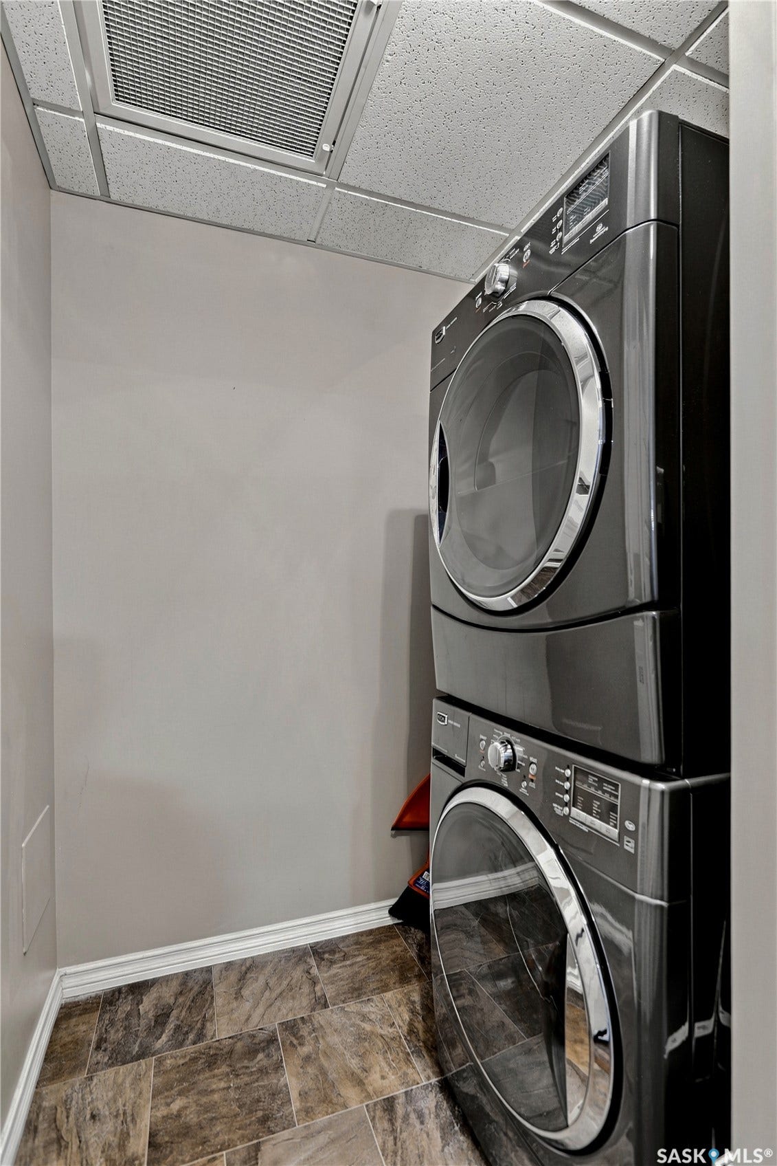 Stacked washer and dryer unit with a dark finish