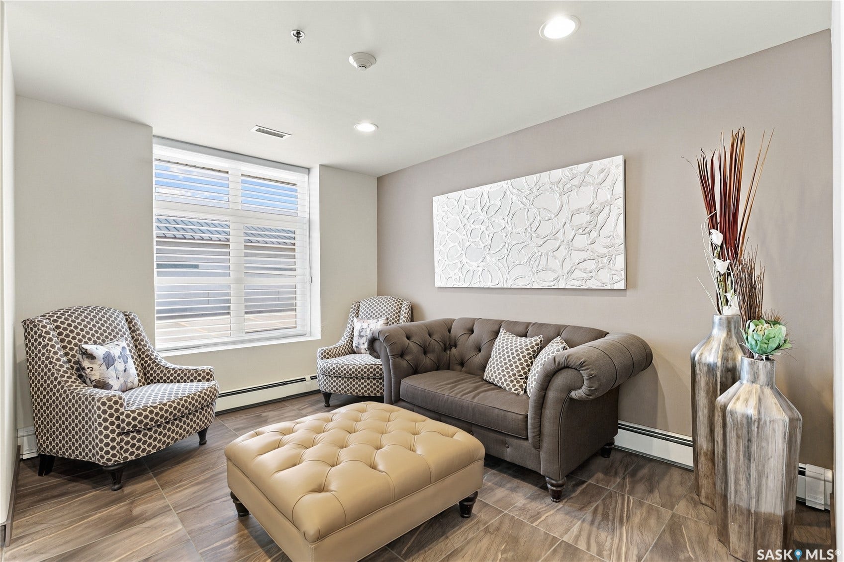 Recessed lighting, large window with blinds, wood-finish flooring, and light-toned wall paint
