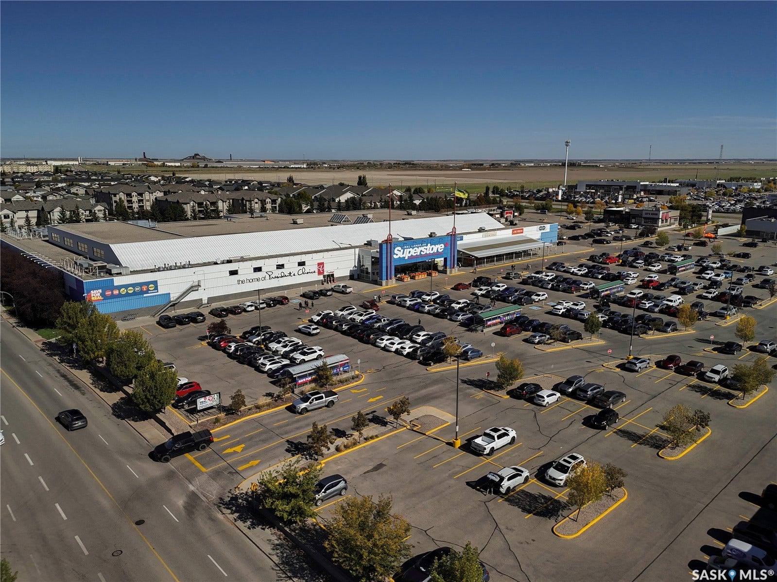 Large retail building with extensive surface parking, prominent signage, and direct road access