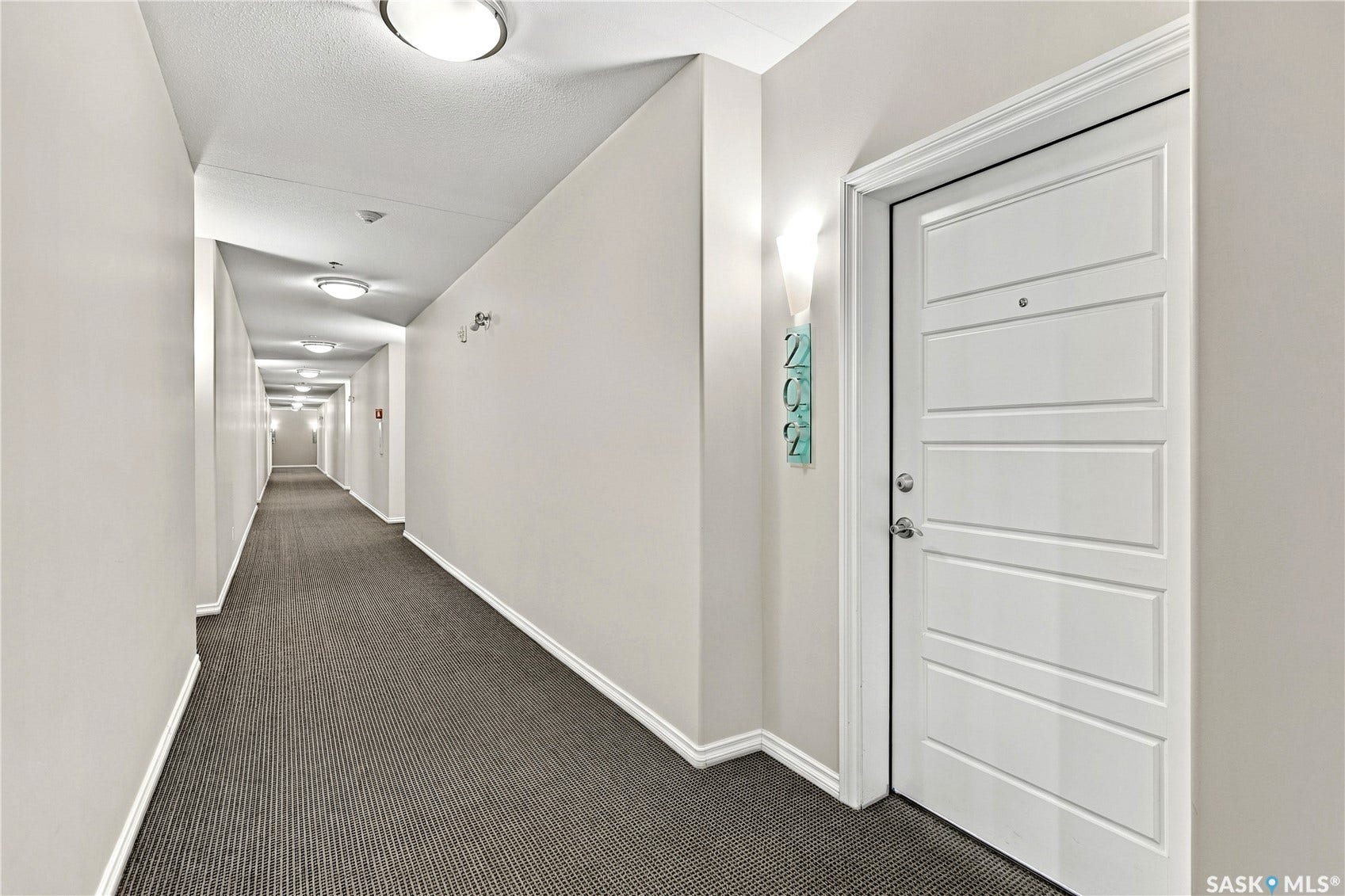 White paneled entry door with polished chrome hardware