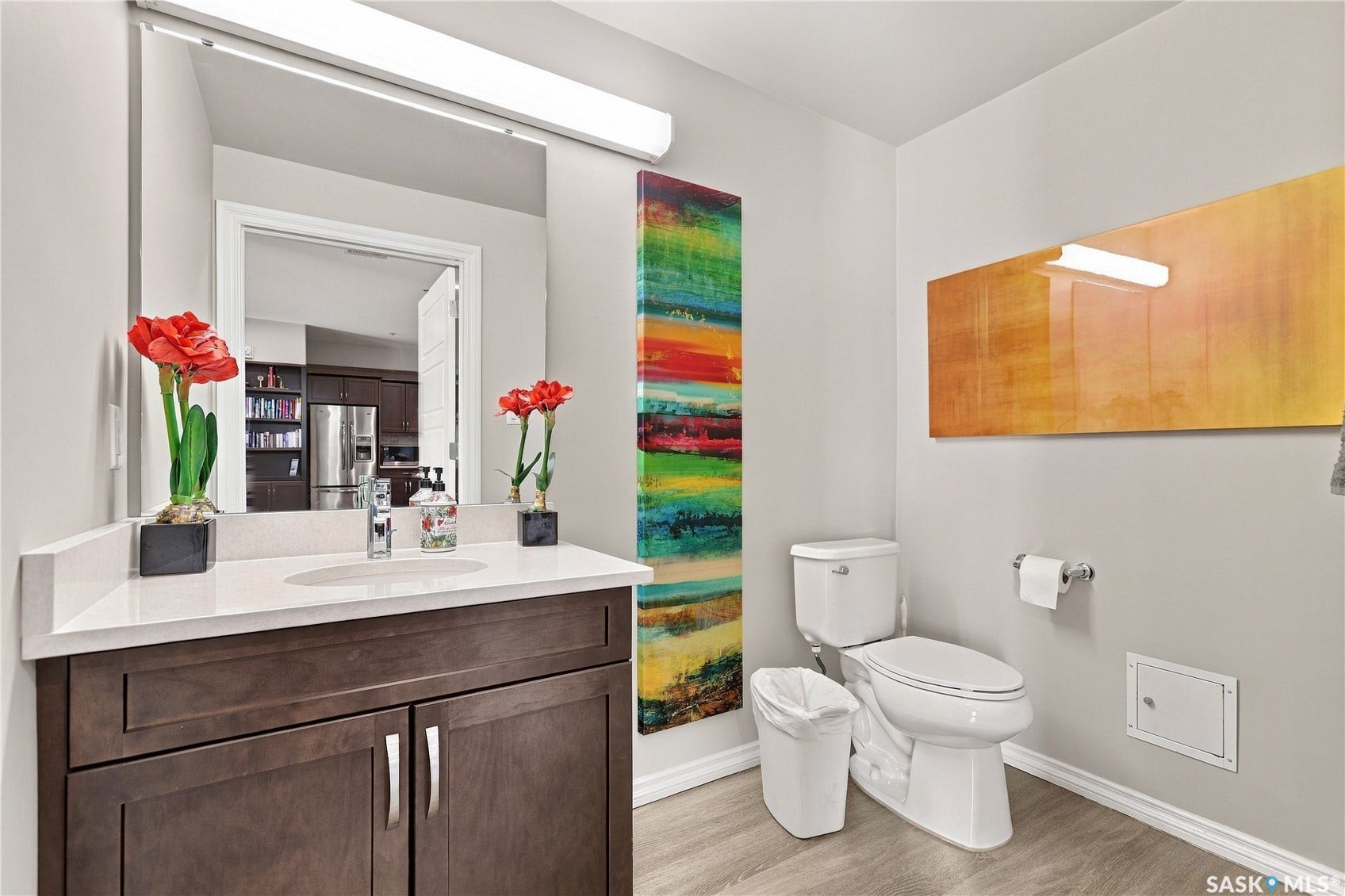 Dark wood-finish vanity with a white countertop and undermount sink