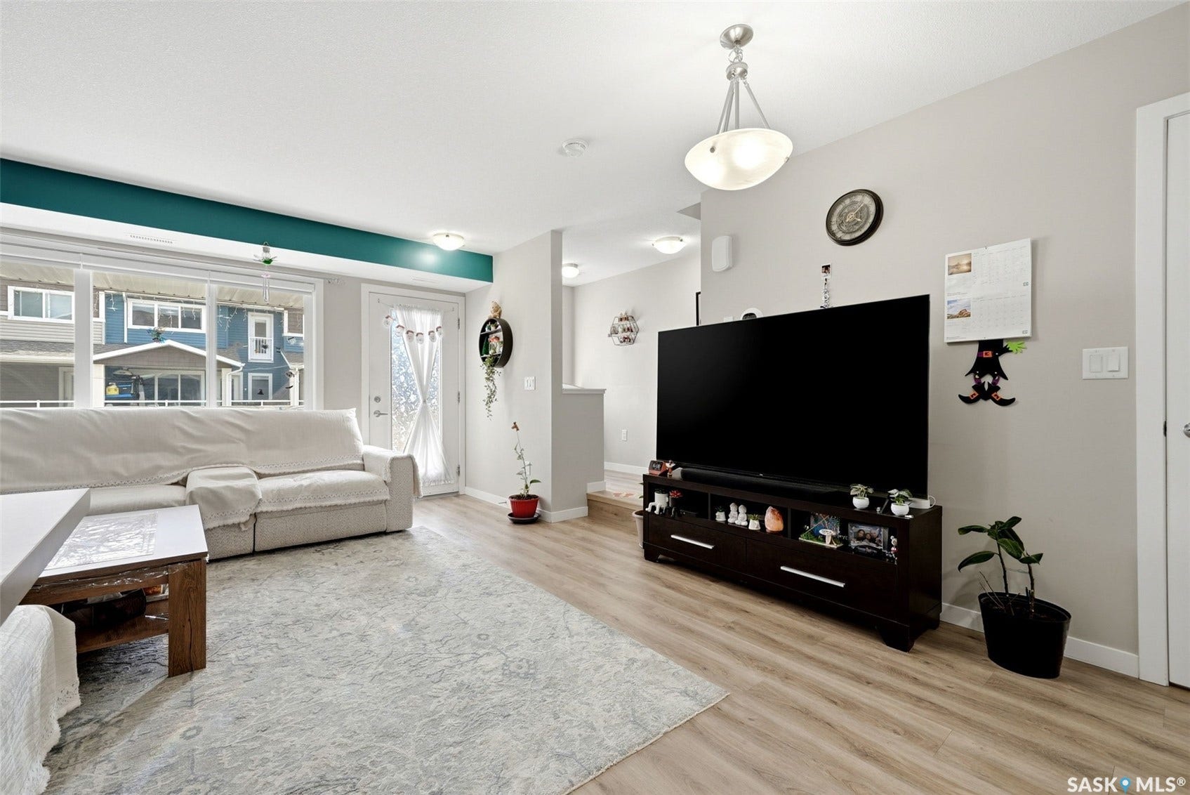 Wood-finish flooring throughout, complemented by a contemporary ceiling light fixture
