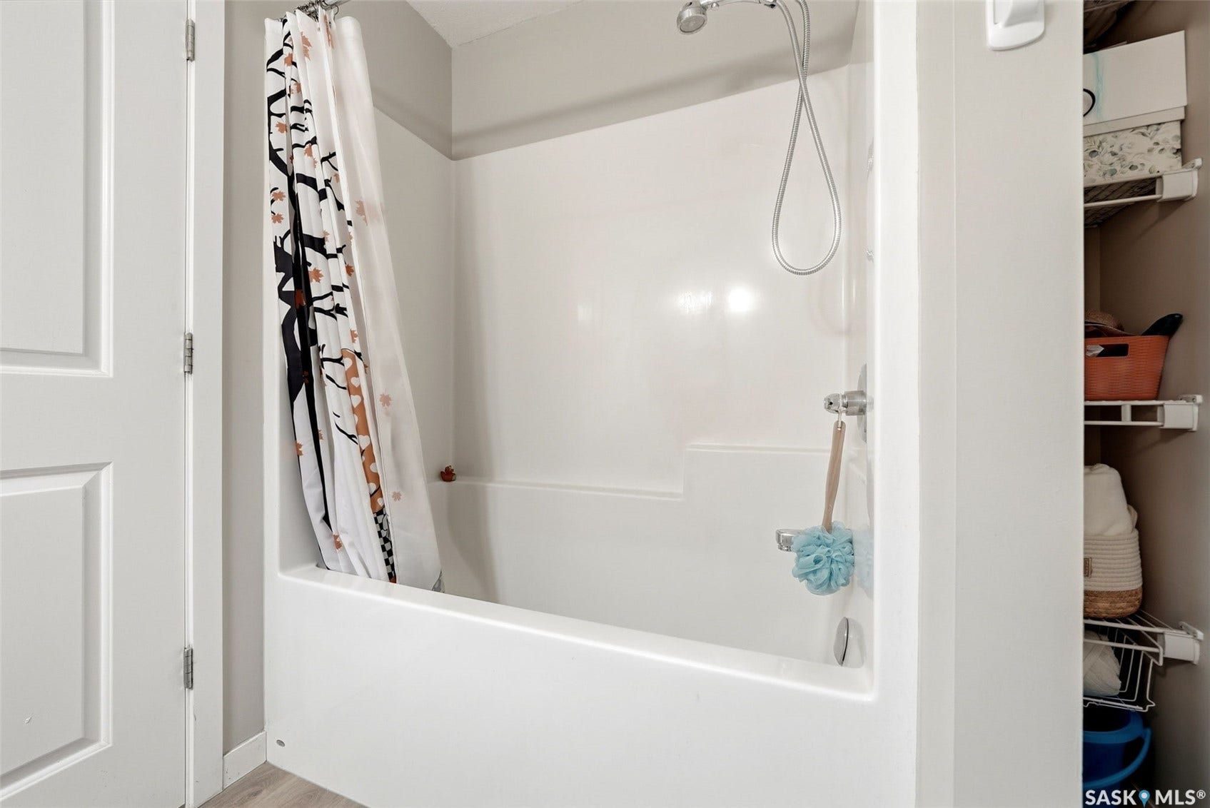 White fiberglass tub/shower combination with chrome fixtures