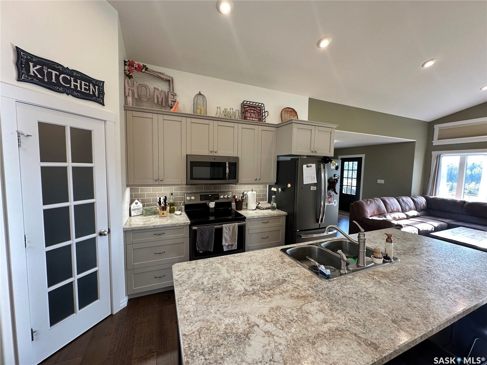 Light-toned cabinetry with coordinating hardware. Walk in pantry with Floor to Ceiling shelves.