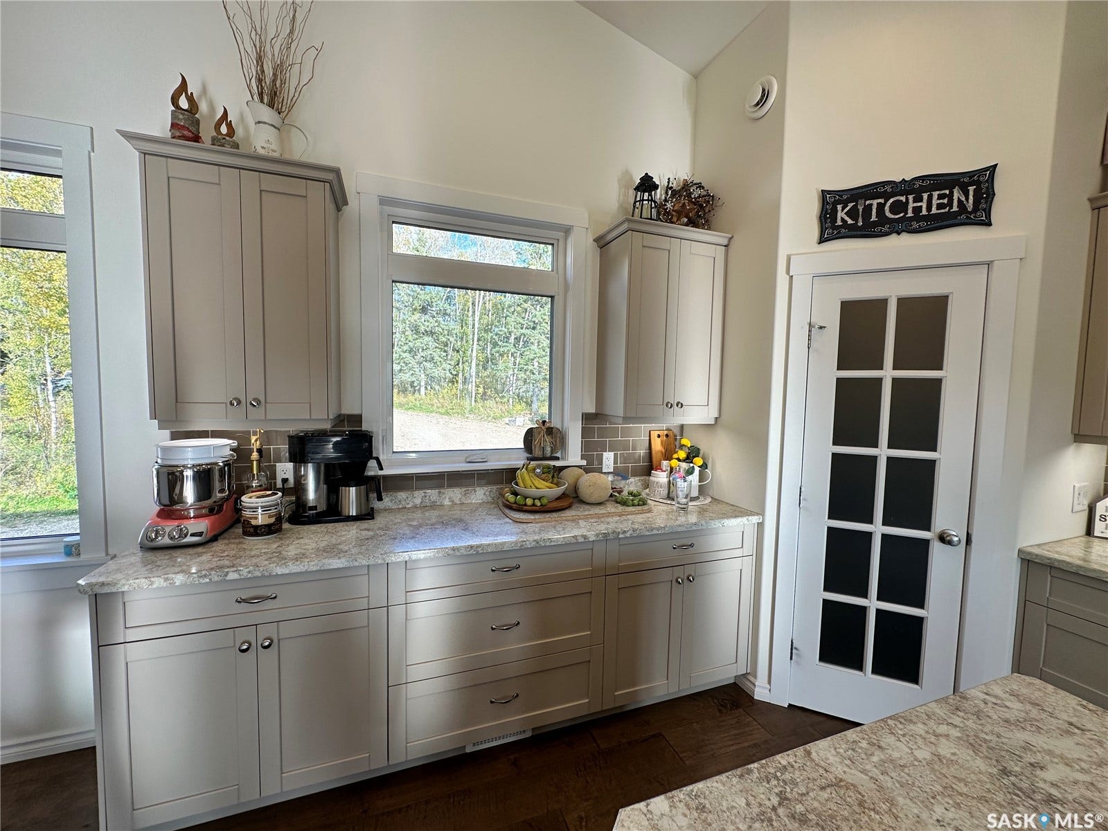 Light-toned cabinetry with coordinating hardware. Walk in pantry with Floor to Ceiling shelves.