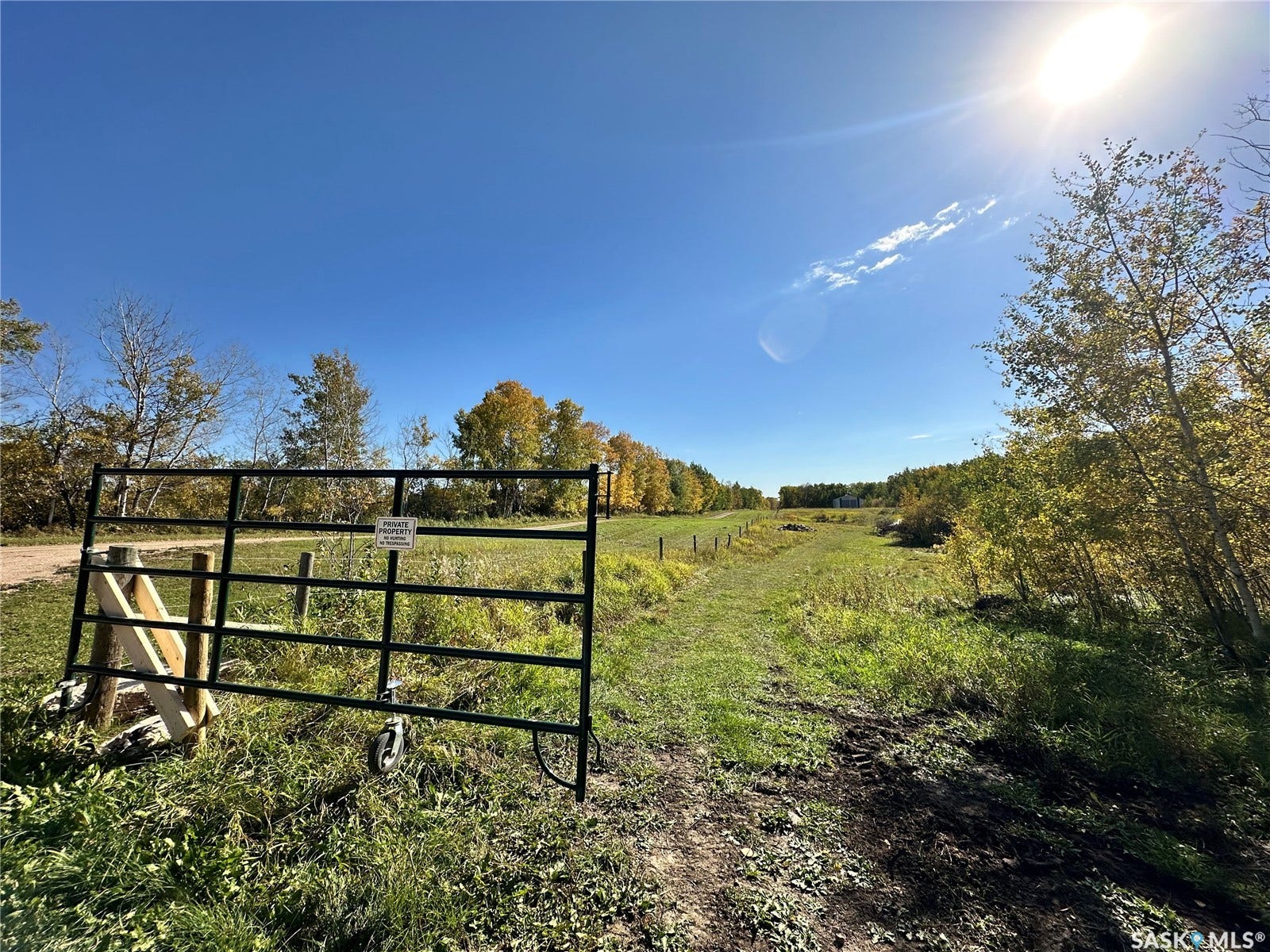 Expansive open field with a metal gate entrance