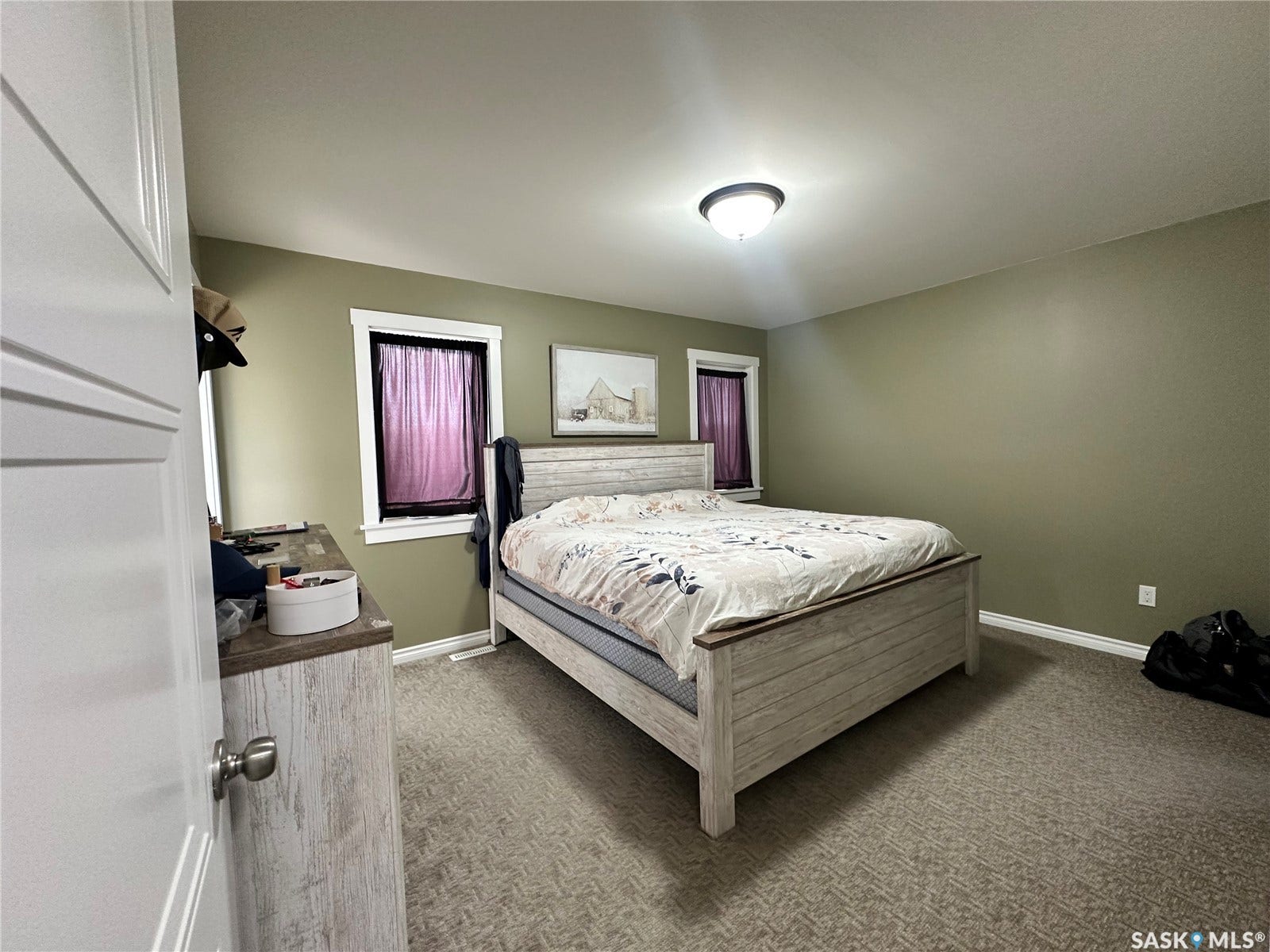 Textured carpeting, recessed windows, overhead lighting, and painted walls