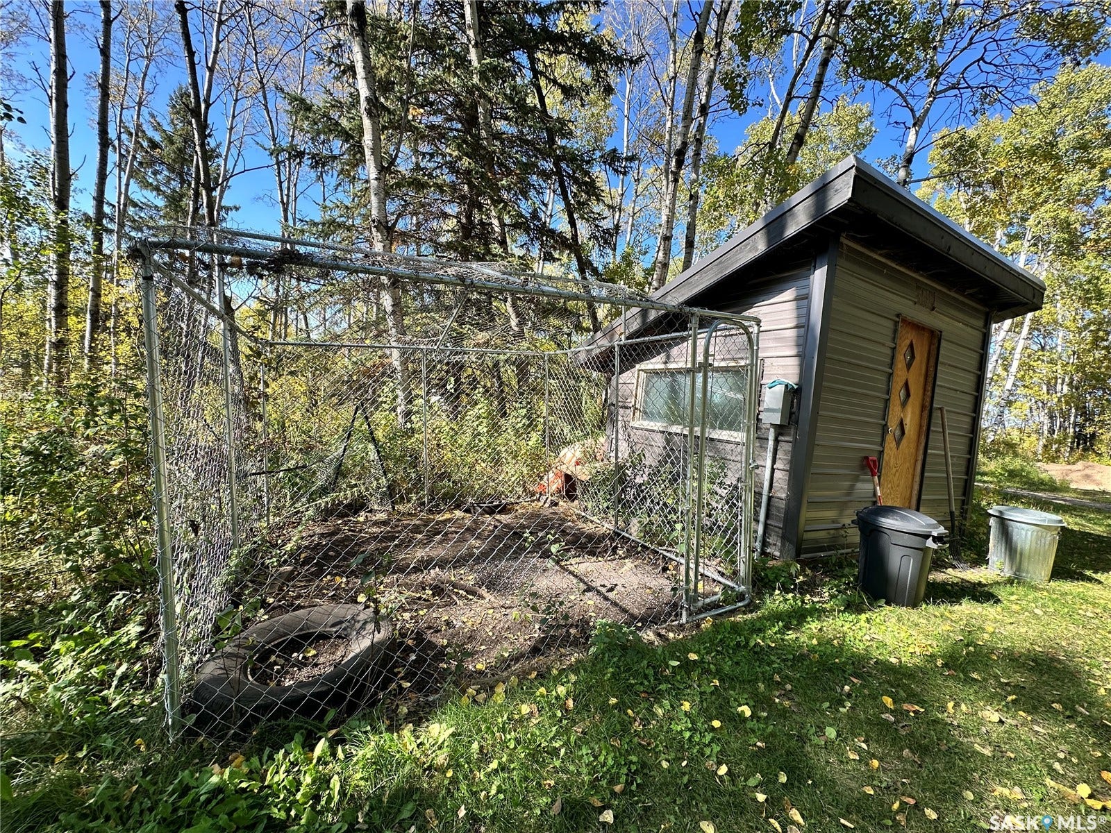 Utility shed with wood-finish siding and a metal roof