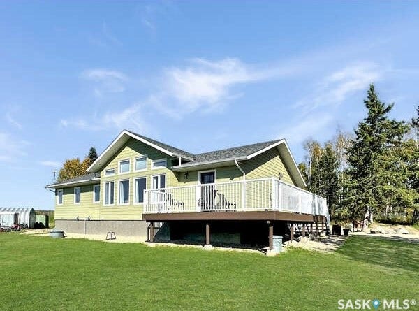 Light green siding exterior with dark shingle roof