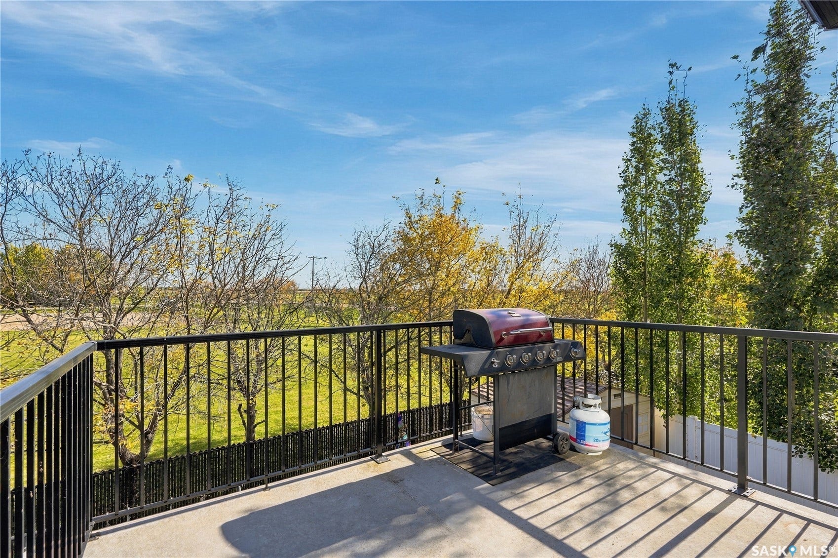 Spacious east/south facing balcony featuring black metal railings