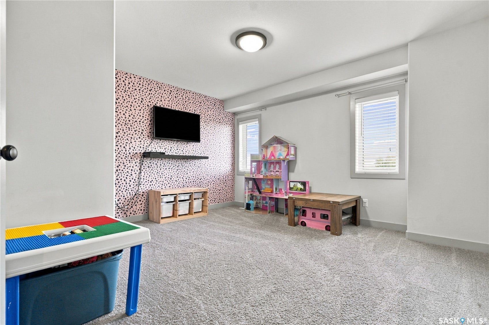 Large bedroom on the 2nd floor with an accent wall and tons of natural light