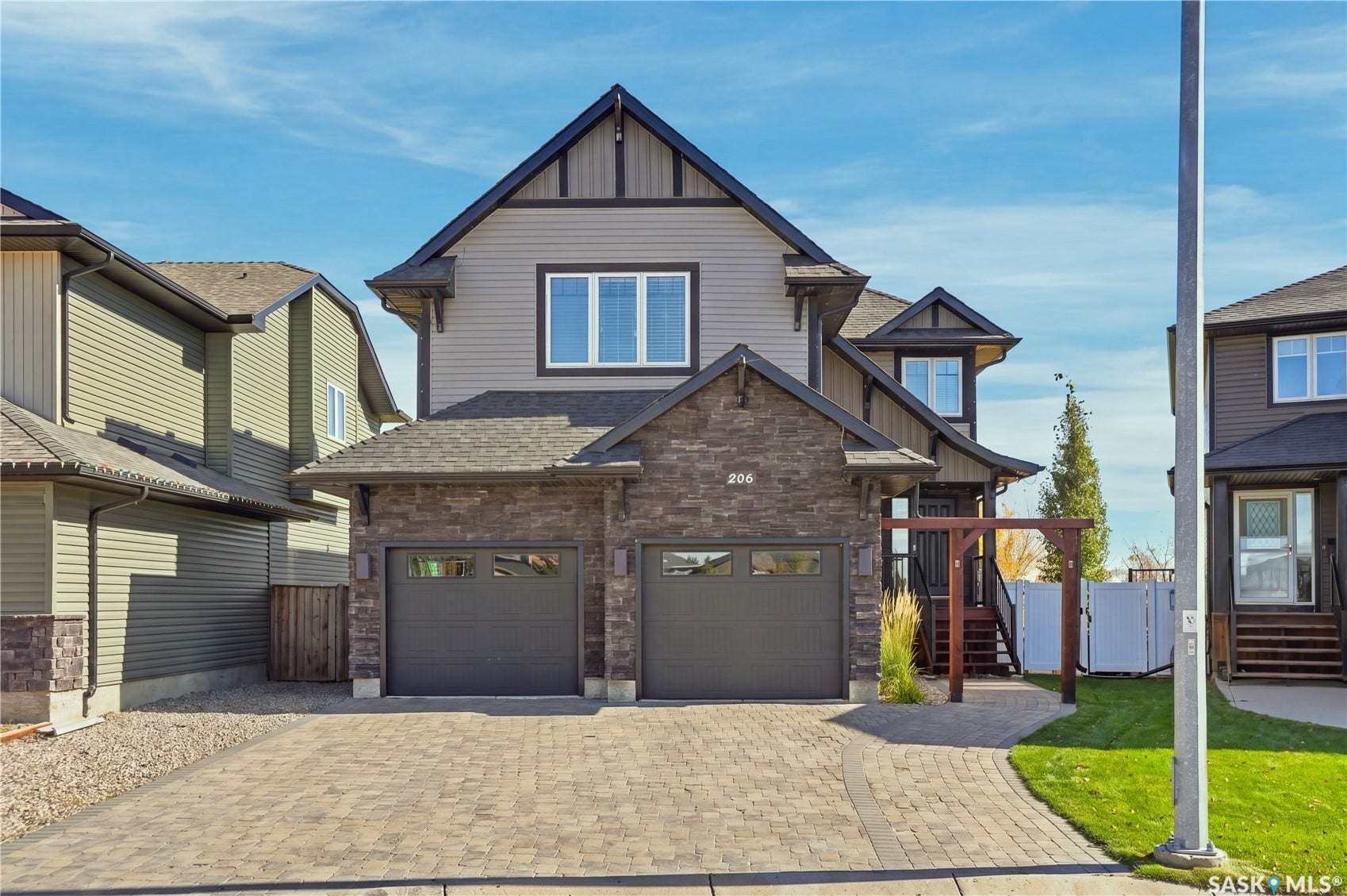 Stone and siding exterior with dark trim accents