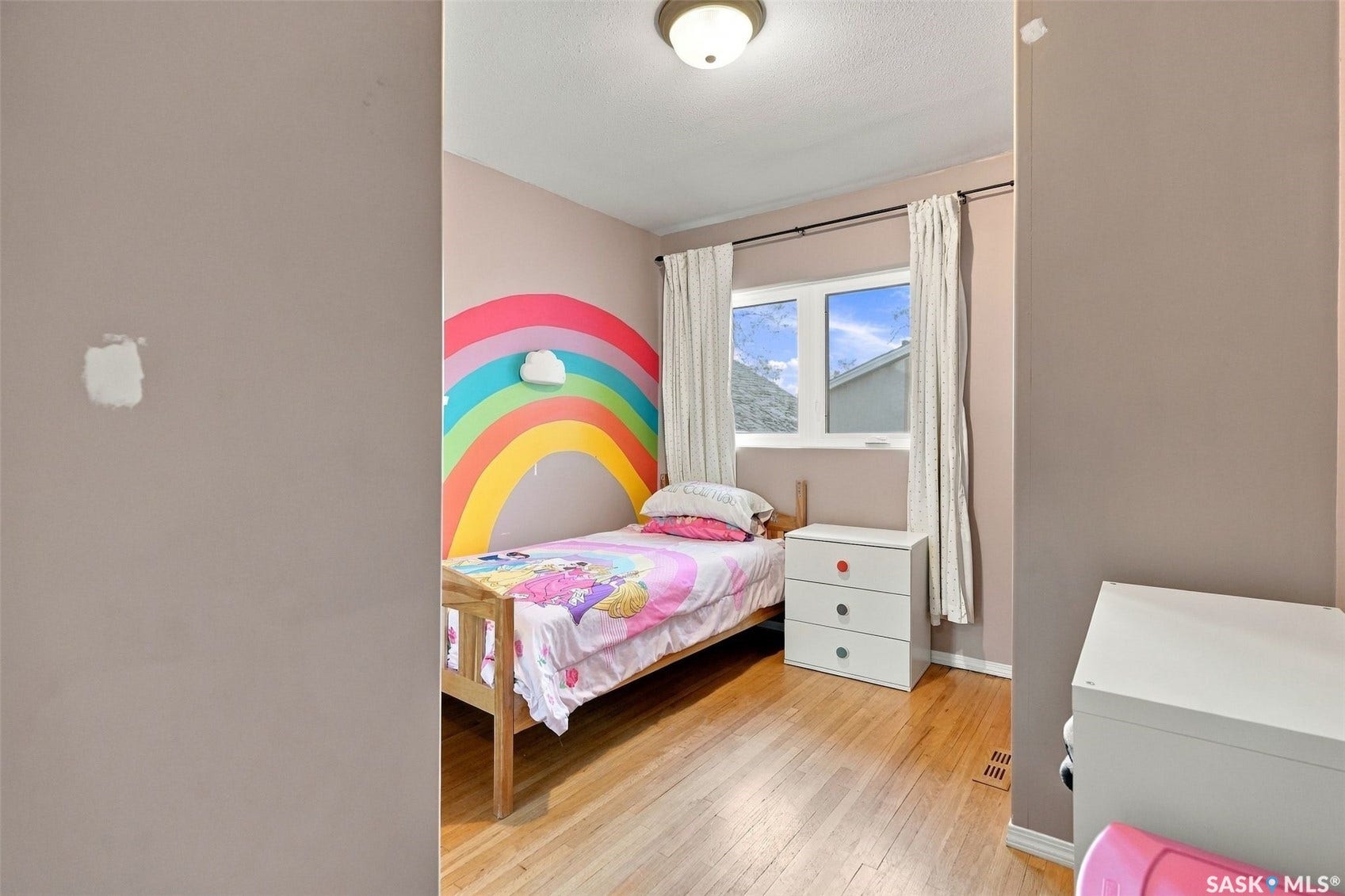 Hardwood flooring with a white-framed window