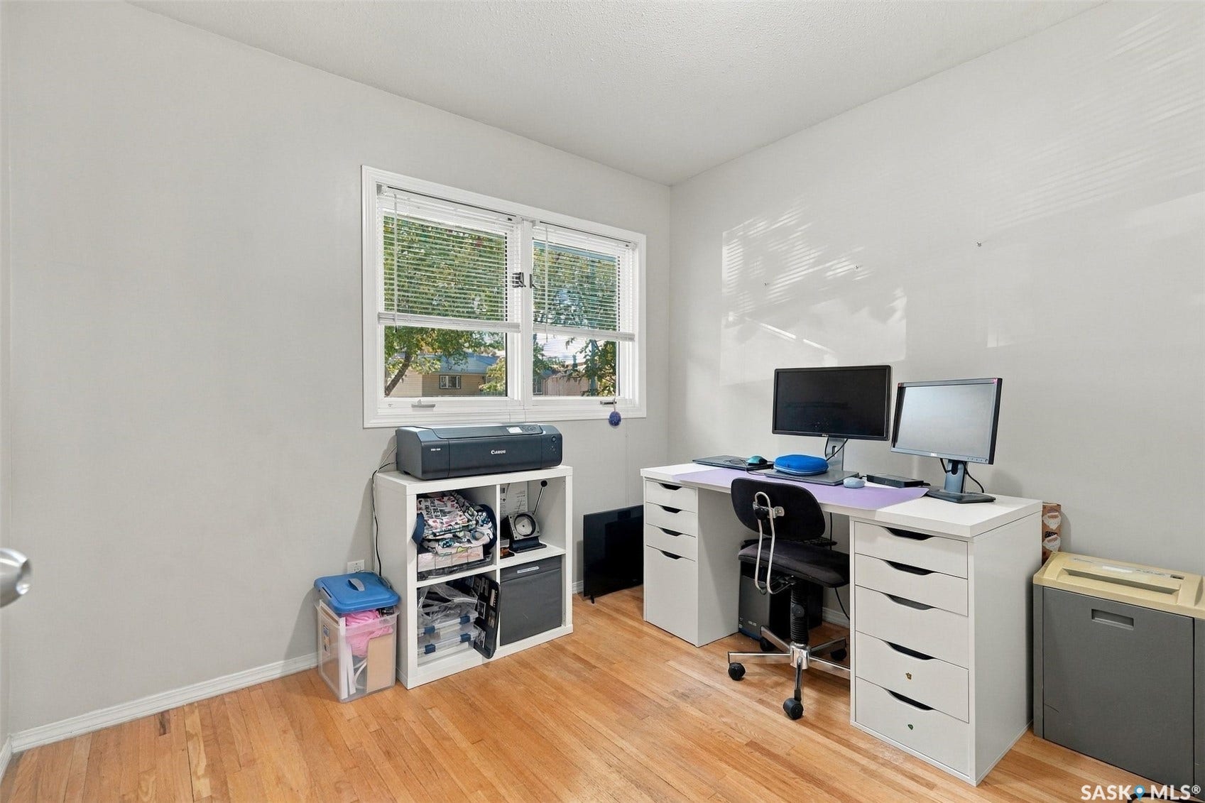Hardwood flooring, painted walls, window with blinds