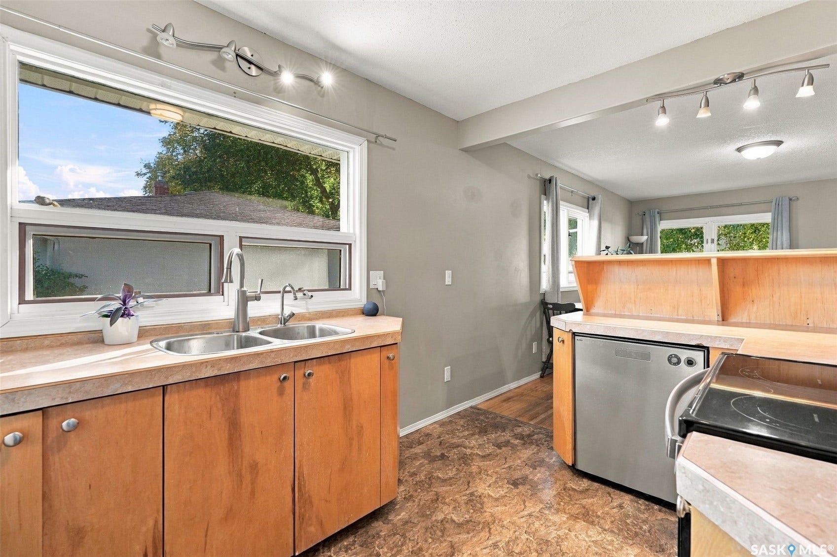 Double basin stainless steel sink with a gooseneck faucet