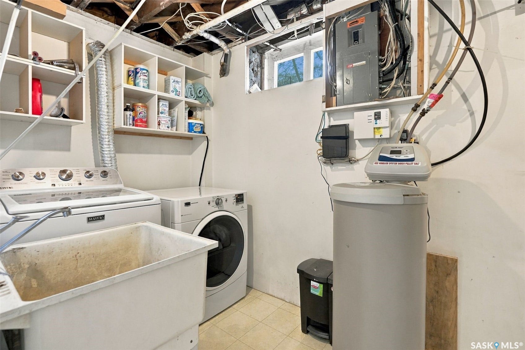 Vanity with an integrated sink, dual-handle faucet, and white cabinetry