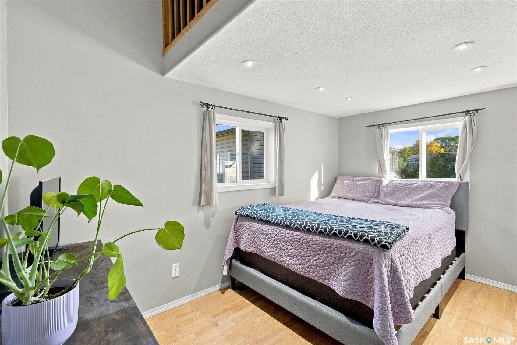 Wood-finish flooring throughout, complemented by light gray walls