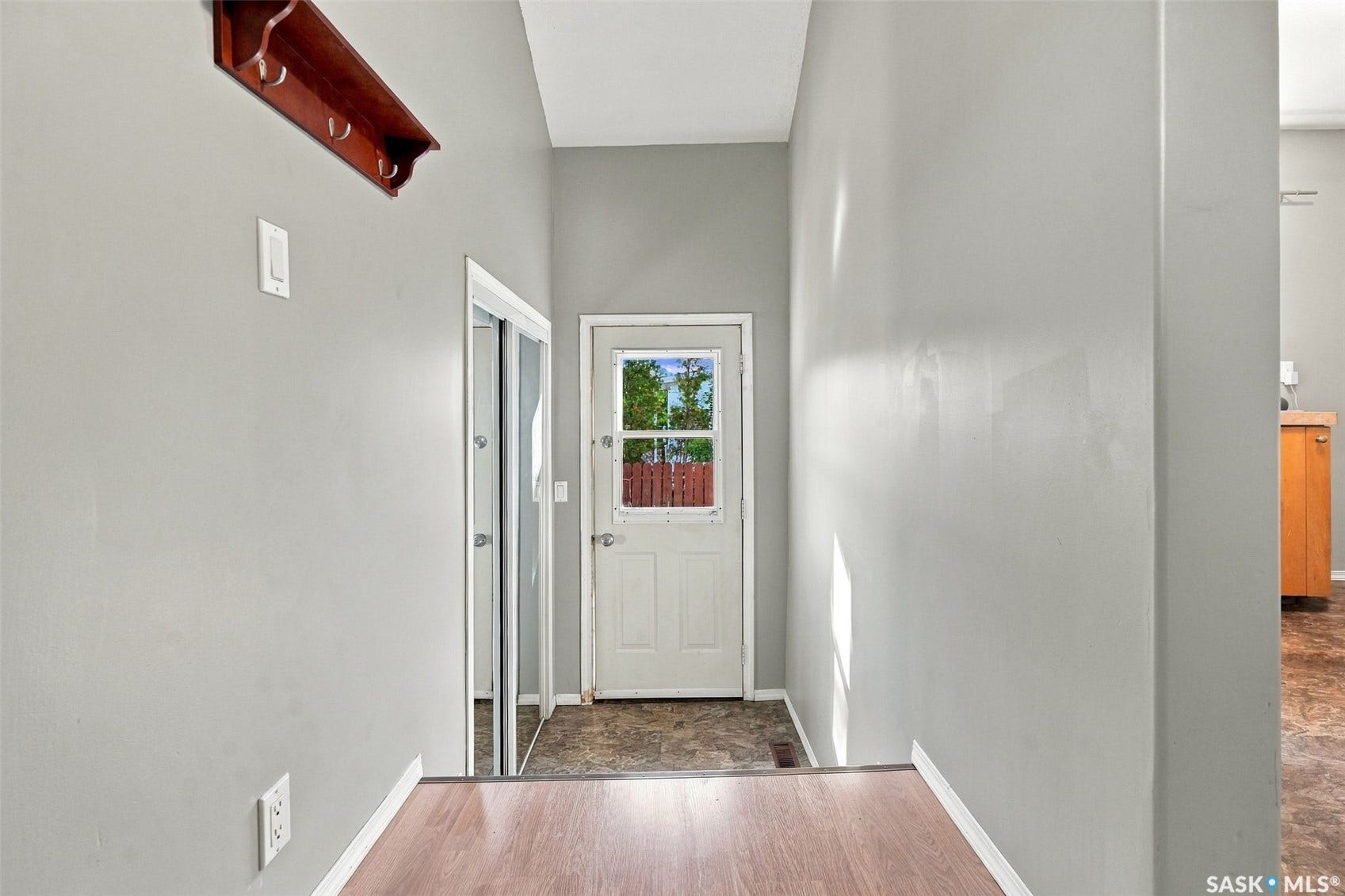 Wood-finish flooring leading to a split-level entrance