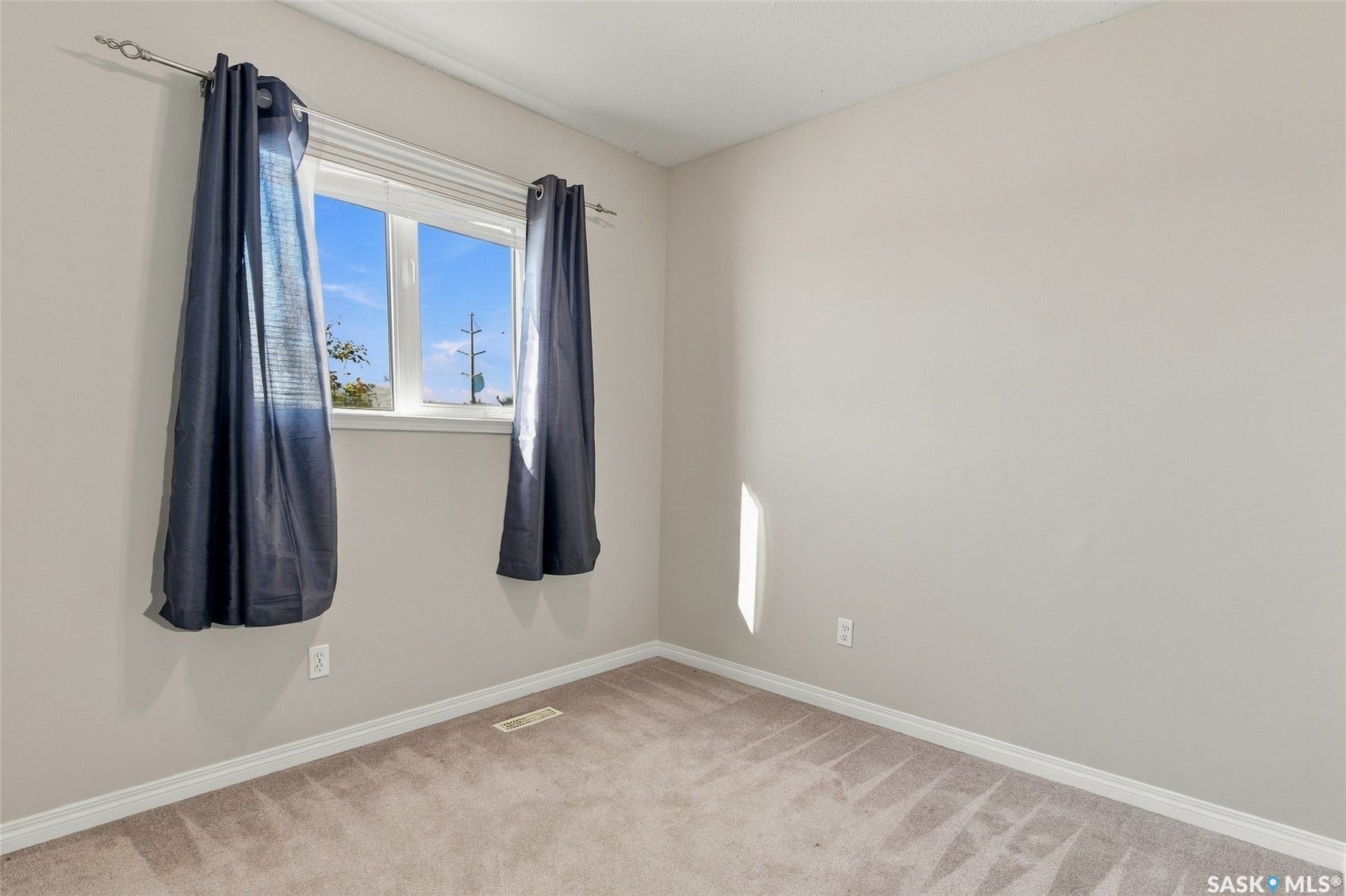 Neutral-toned walls complement plush carpet flooring
