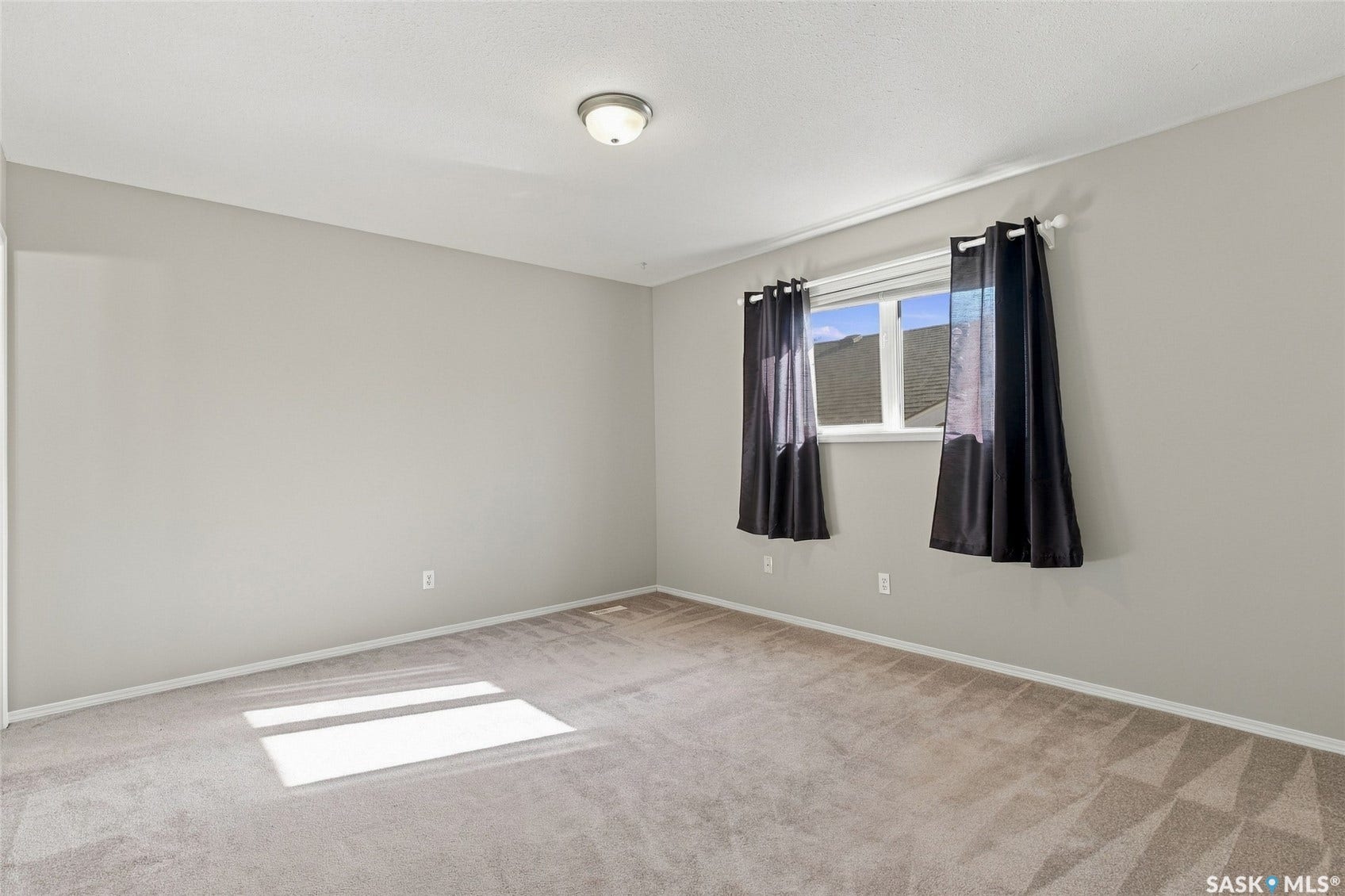 Wall-to-wall carpeting and a ceiling-mounted light fixture