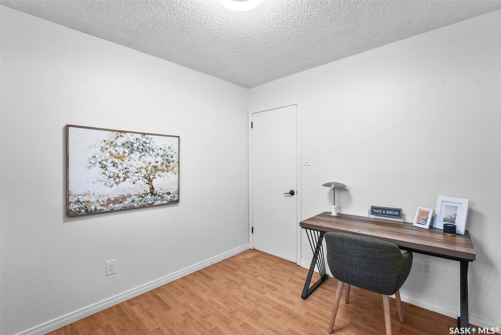 Wood-finish flooring with white walls and a white ceiling