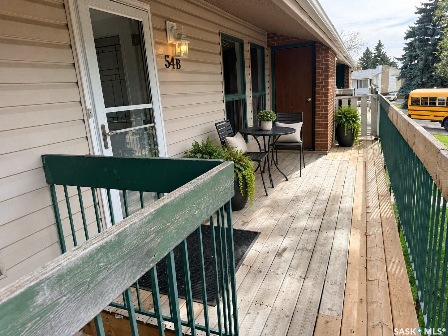 Entry porch with horizontal siding and a wood deck
