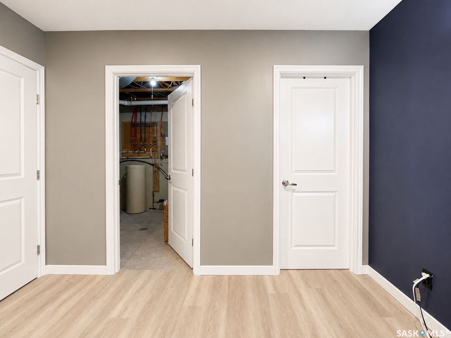 Light wood-finish flooring with white trim