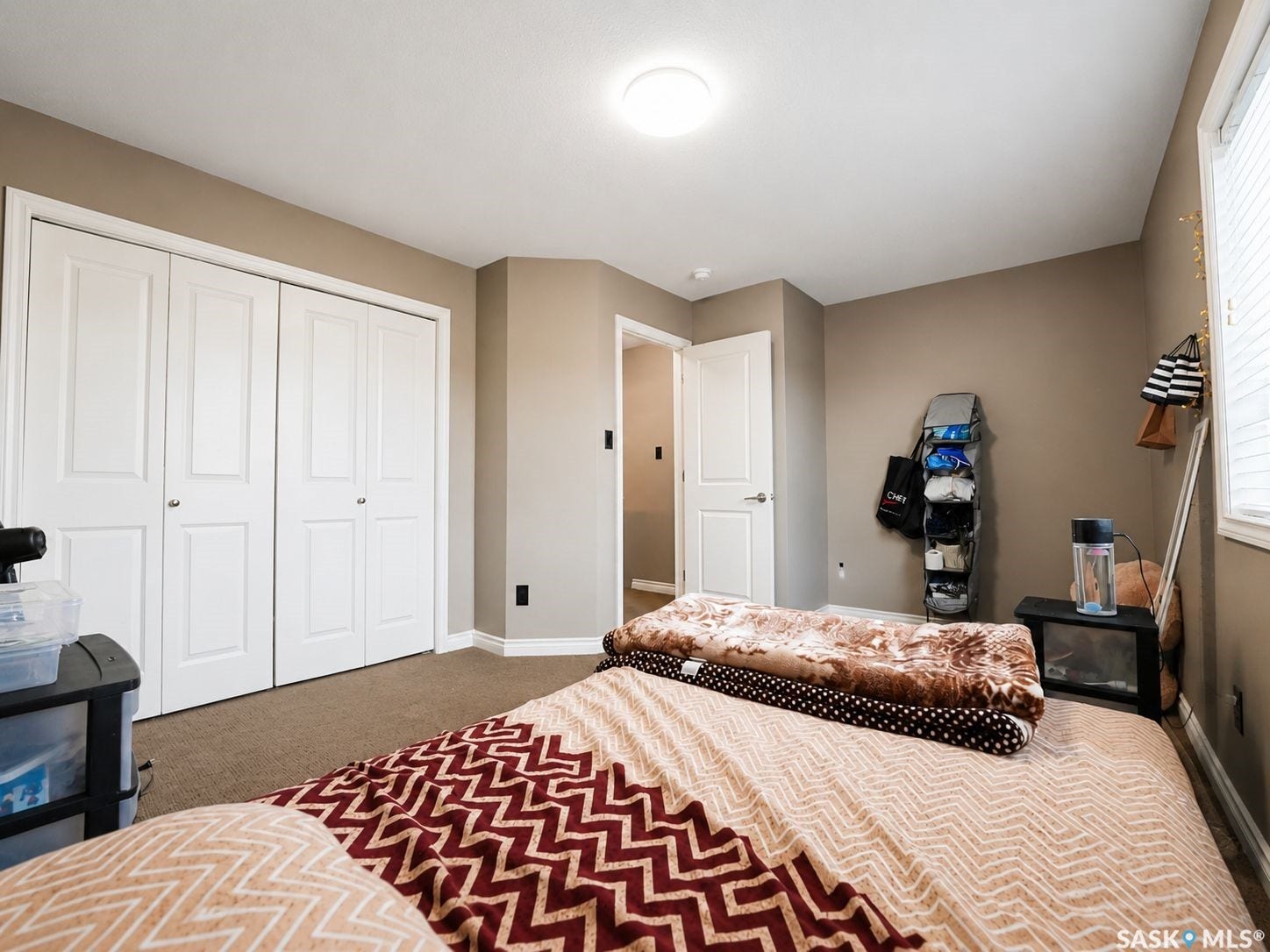 Neutral-toned walls complement the carpeted flooring