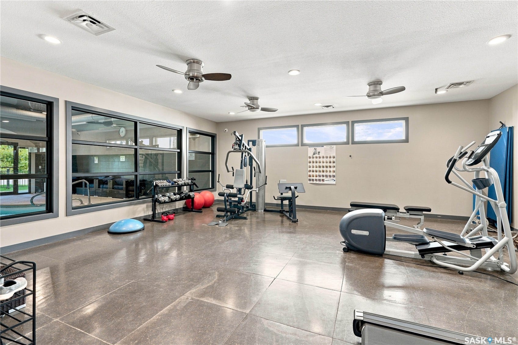 Fitness room featuring large windows, recessed lighting, and ceiling fans