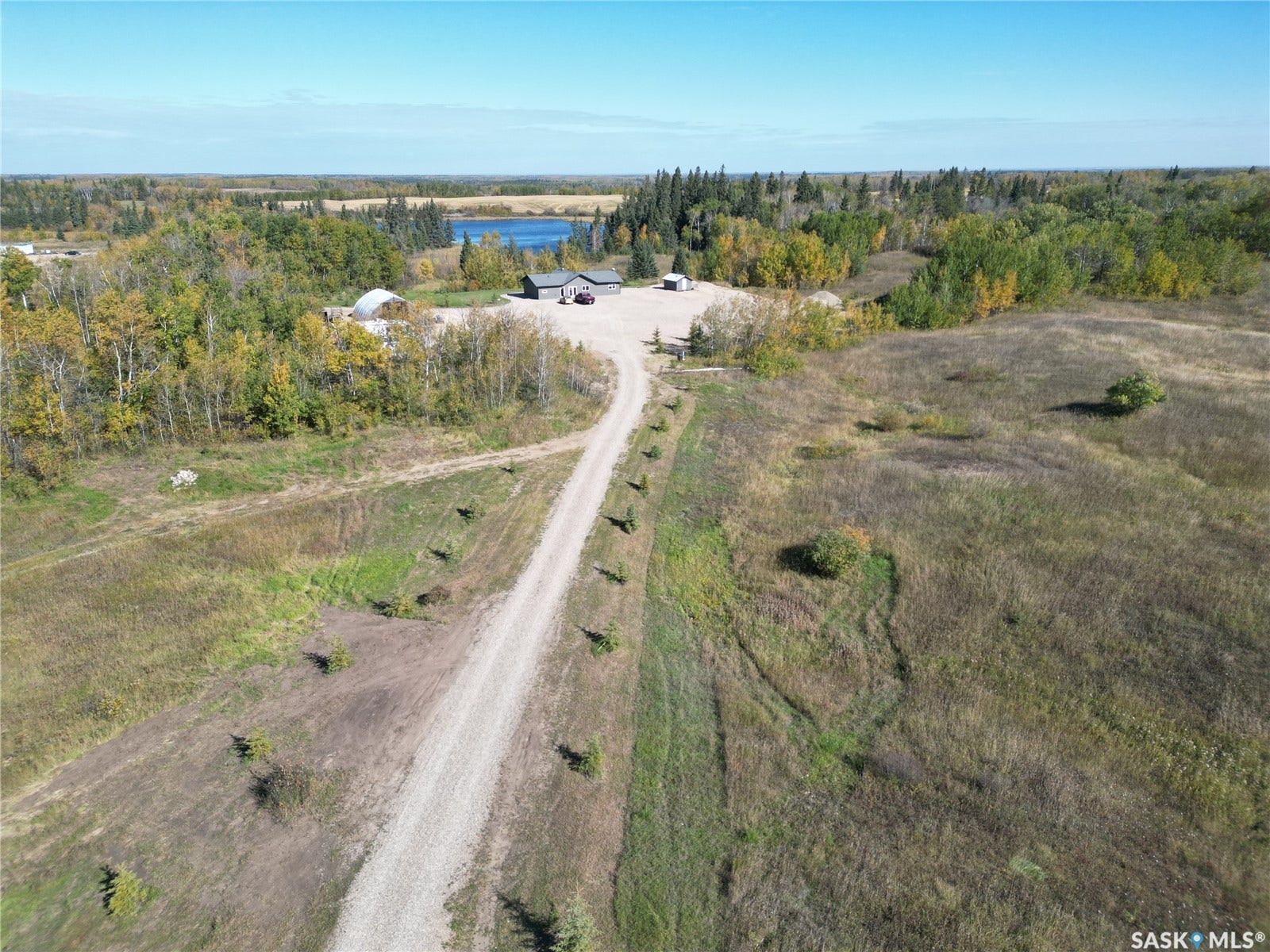 Gravel access road with established plantings