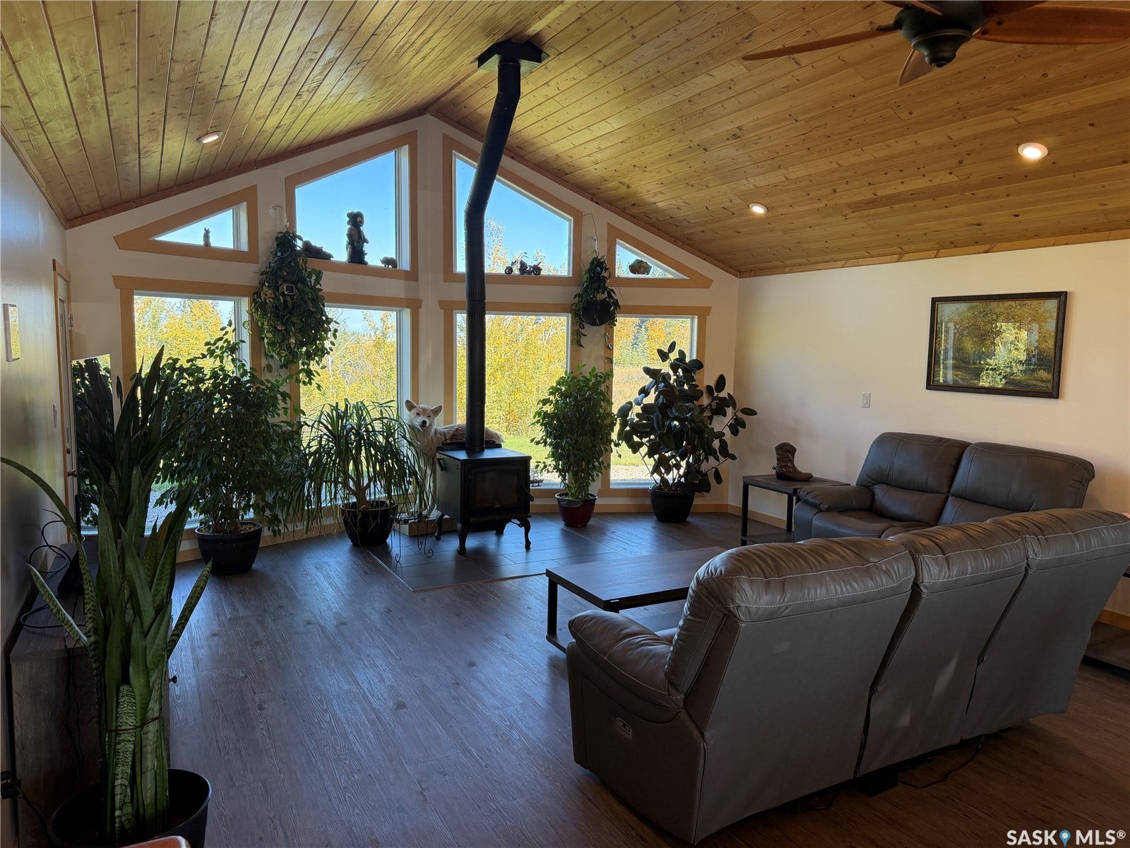 Vaulted wood-paneled ceiling with recessed lighting and ceiling fan