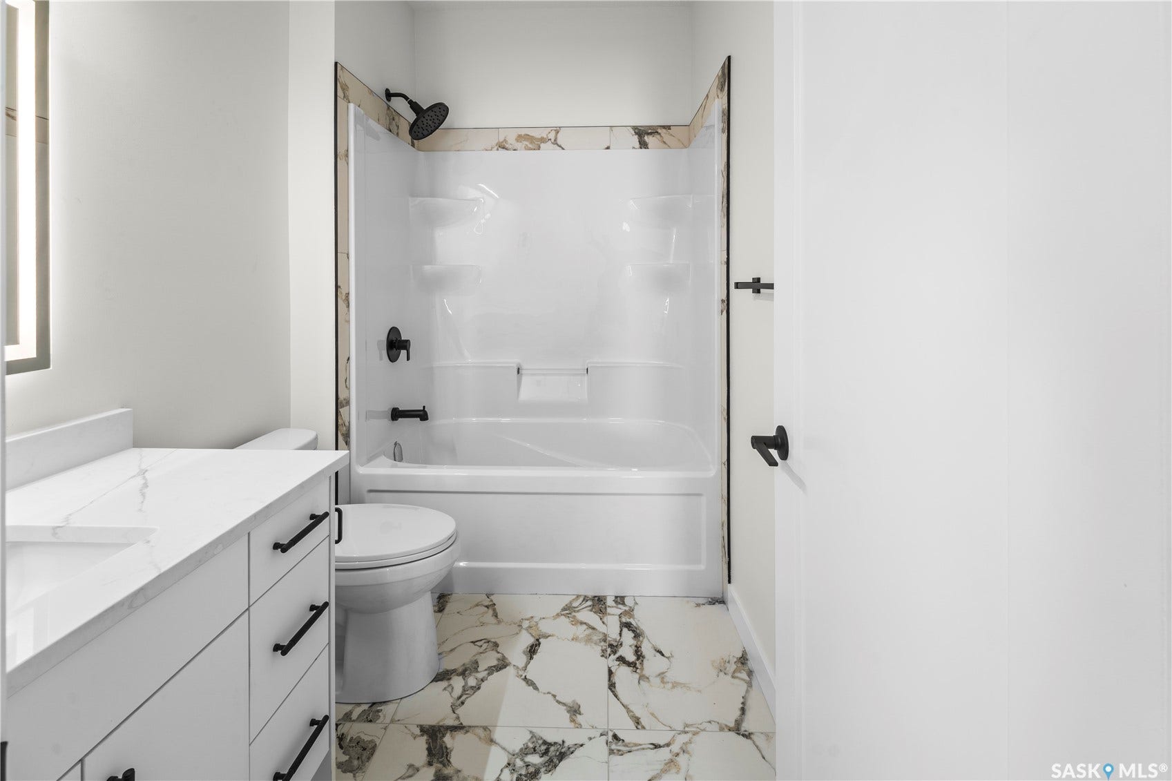 White vanity with ample drawer storage, integrated sink, and white countertop