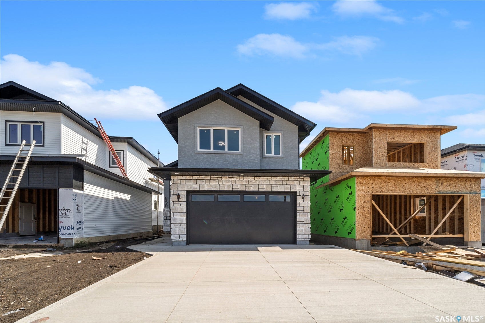 Contemporary two-story exterior with a stone veneer facade, a dark asphalt shingle roof, and a concrete driveway