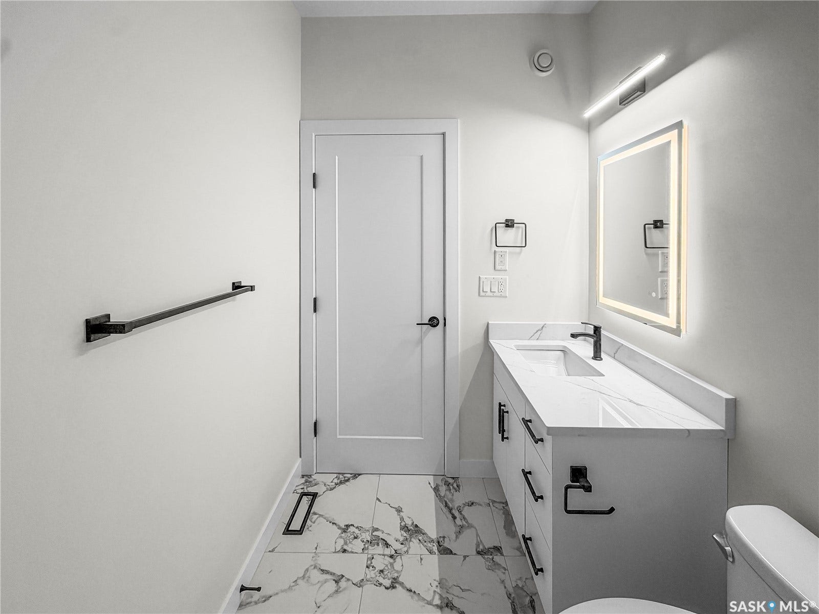 Vanity with a white finish, undermount sink, and a black faucet