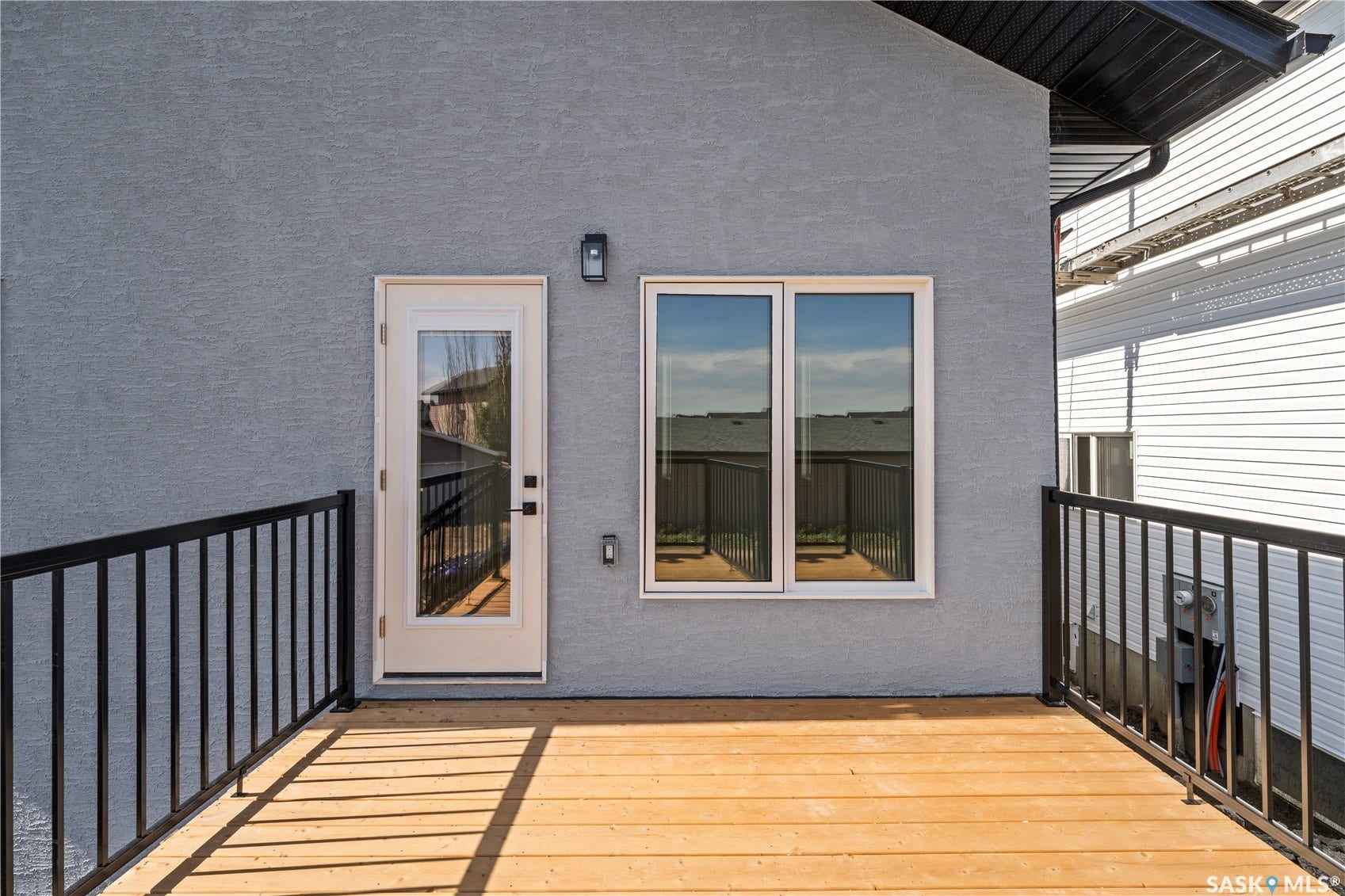 Wood-tone decking with black metal railings