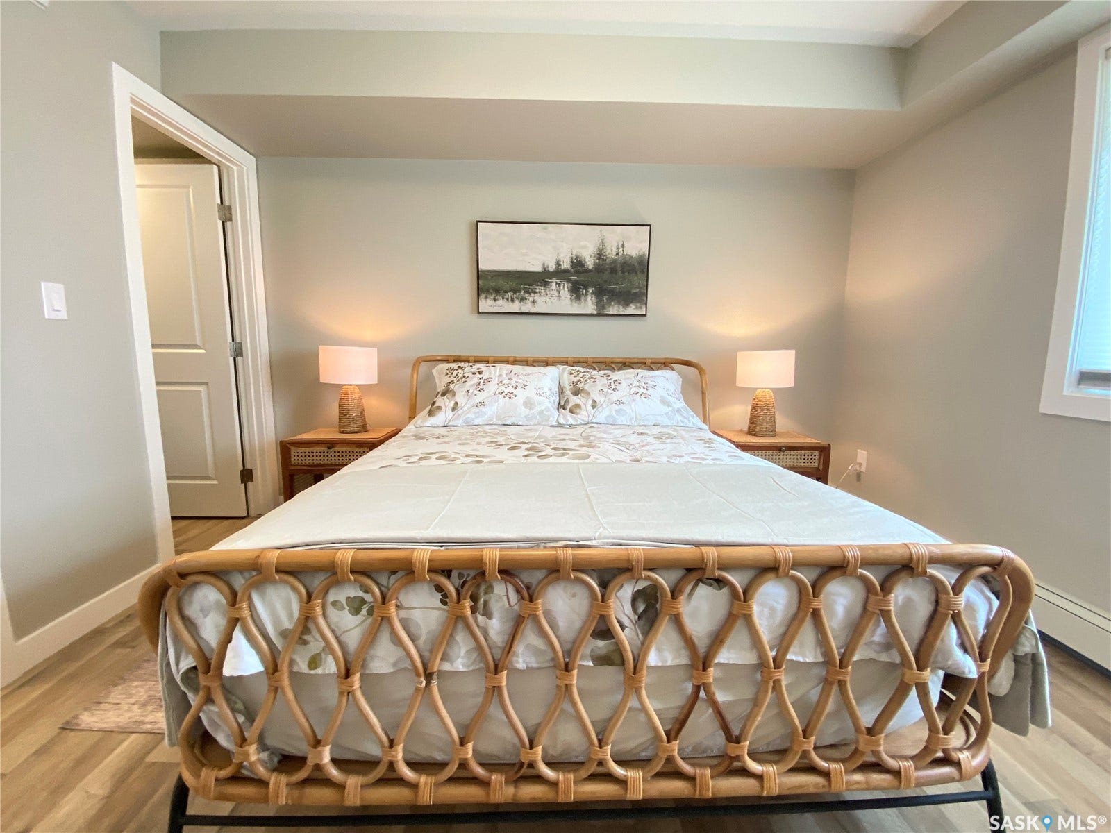 Light wood-finish flooring, neutral wall tones, and white trim