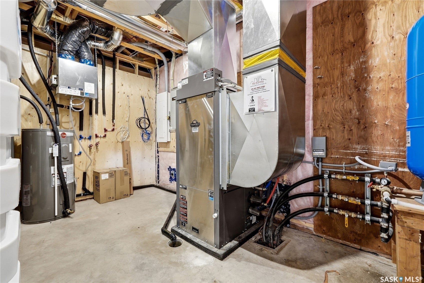 Utility space featuring a water heater, furnace, and exposed mechanical systems