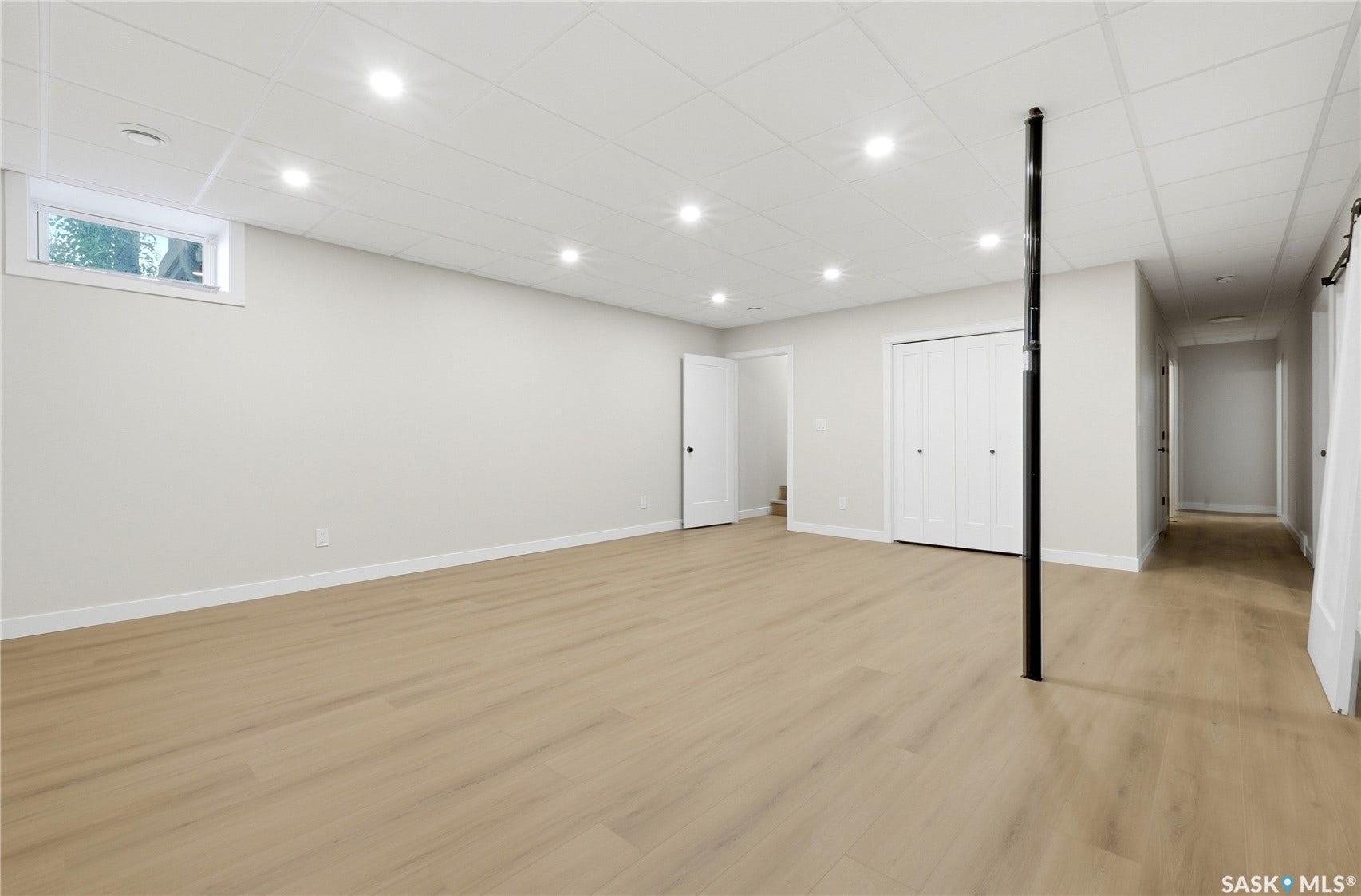 Recessed lighting, wood-finish flooring, white walls, white trim, and a drop ceiling