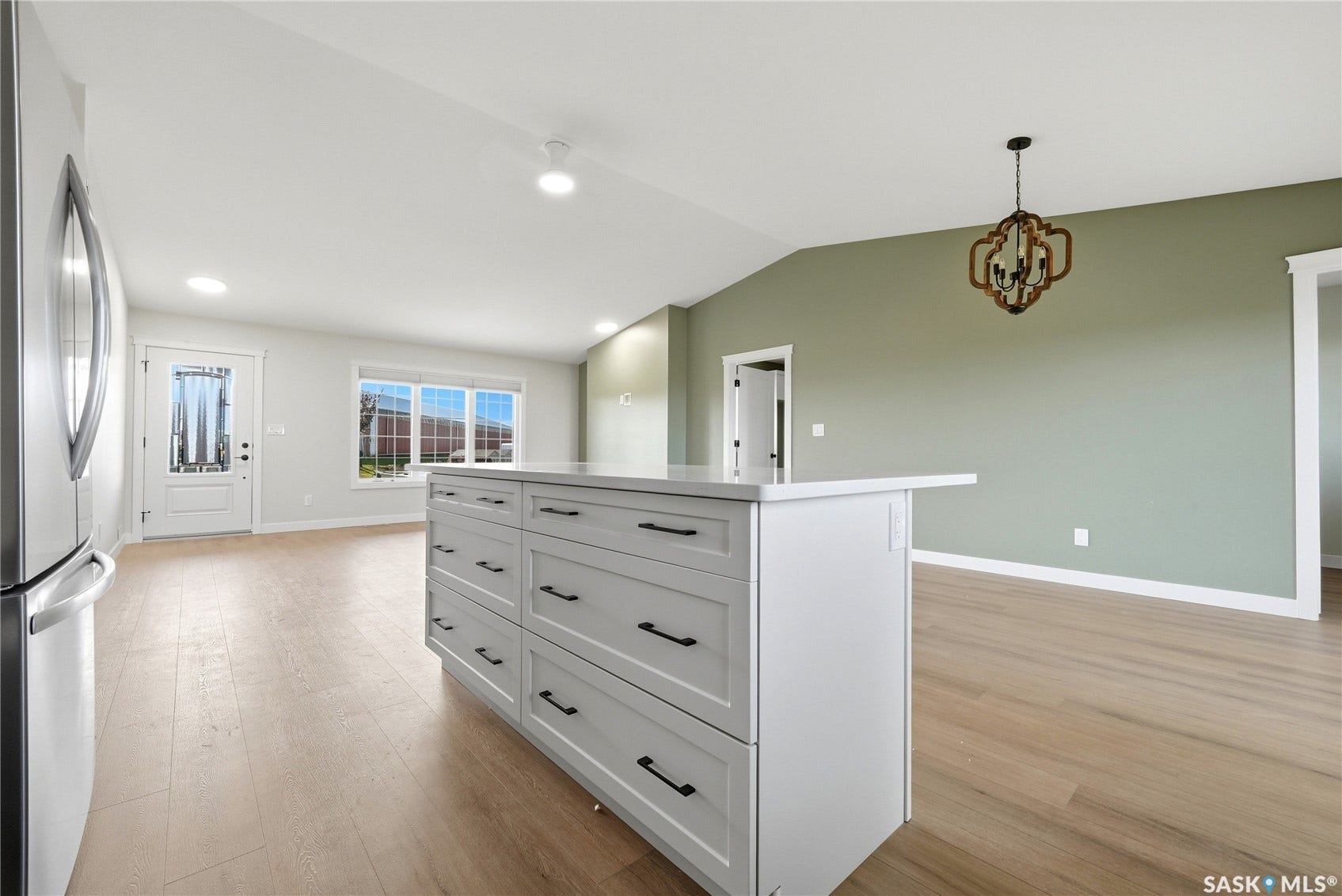 Kitchen island with stone-finish countertop, wood-finish flooring, and recessed lighting