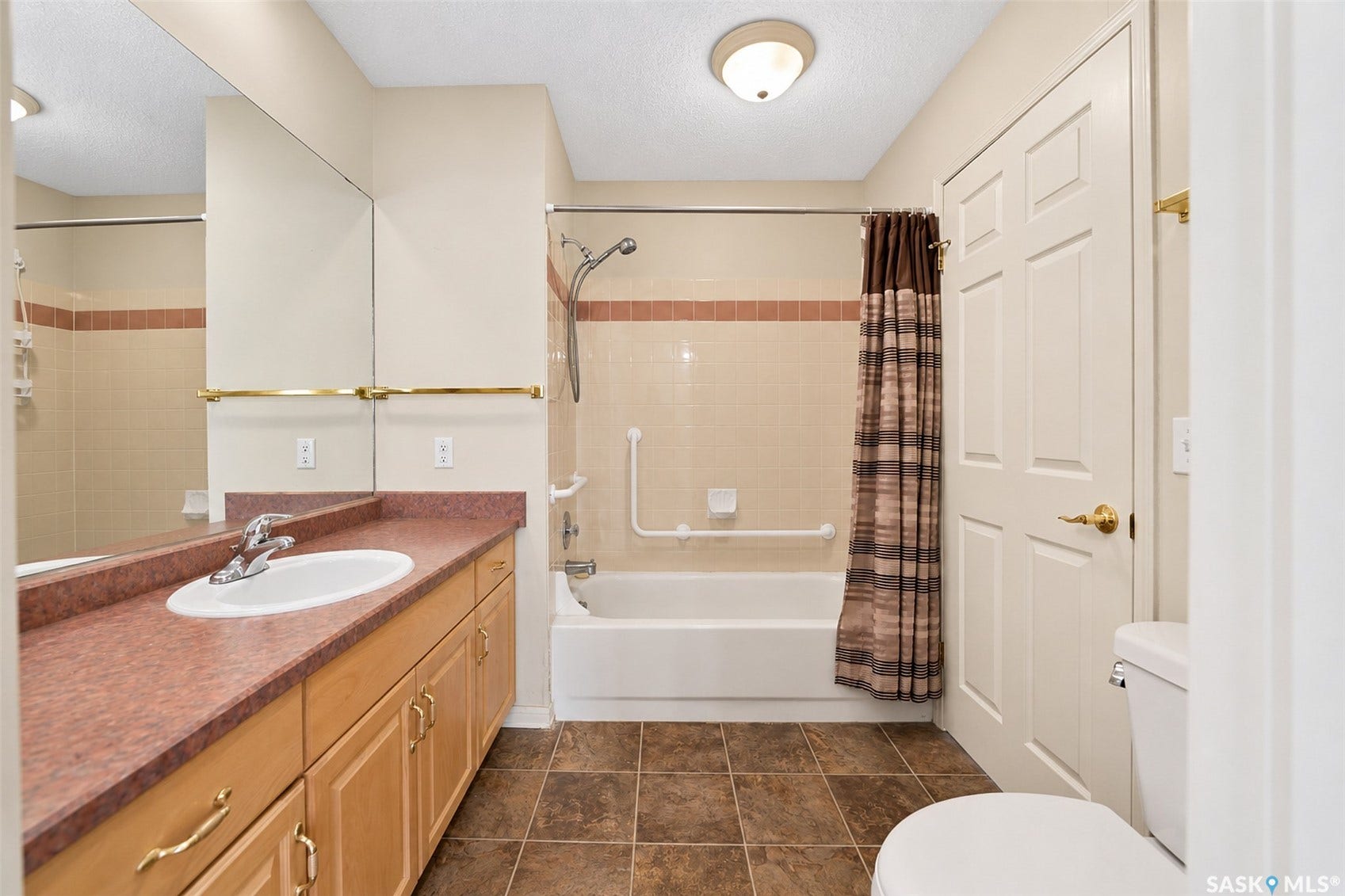 Neutral-toned ceramic tile flooring with a full bathtub and shower combination